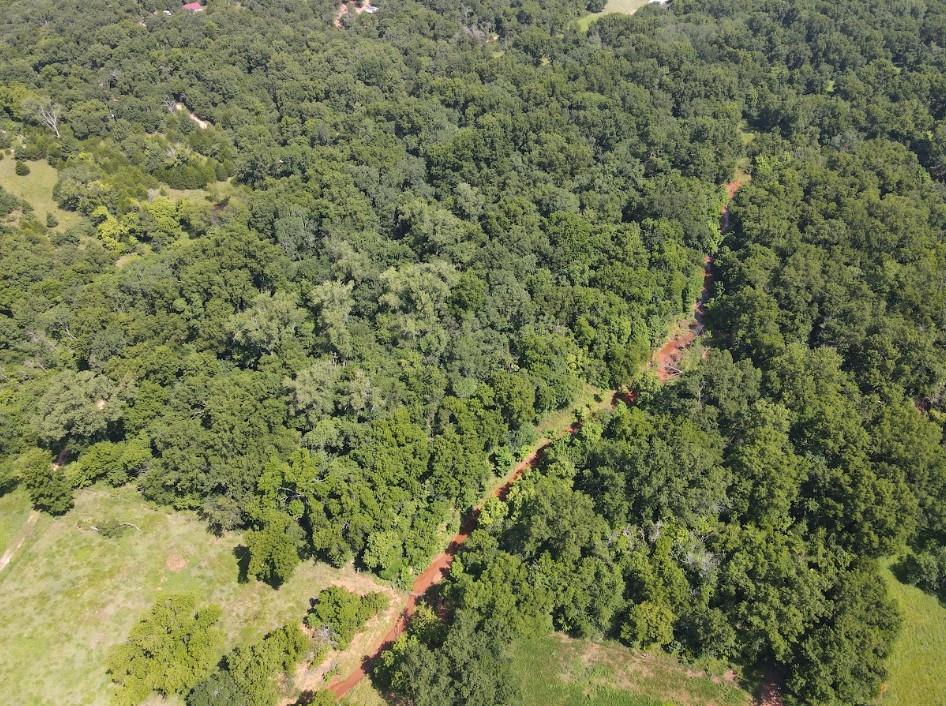 A bending creek, towering trees, and undisturbed wildlife are calling hunters and outdoor enthusiasts. This 8.33-acre wooded tract is a prime recreational getaway loaded with mature timber, abundant wildlife, and a scenic creek bed that creates an ideal habitat for sizable deer, turkey, and other game. Tucked away in a peaceful, secluded setting, this property offers the privacy and tranquility you've been searching for. Whether you're looking for your own hunting retreat, a place to camp, or the perfect spot to build a cabin or dream home surrounded by nature, the possibilities are endless. Enjoy the quiet, explore the woods, and own your own slice of Oklahoma paradise.
