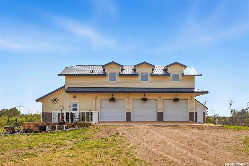 This 80-acre property, located just 5 km from Saskatoon and directly off a paved road, offers a rare combination of privacy, prime location, and future development potential. Providing the perfect balance of seclusion and convenience, it is tucked away from surrounding properties, among the desirable Hidden Ridge Estates acreages.  
The property features a Carriage house, 1232 sq. ft. residence with an open-concept, loft-style design. The three-car (24'x36')heated garage also serves as utility room for drip system holding tank, HWT and connects to an indoor kennel and dog run. There is a spacious mudroom, 2 pc bathroom and office/laundry on the ground floor. The second floor features an open concept kitchen/ dining room and spacious living room with great views of the property. The primary bedroom has lots of space for another work space. In the evening, the Saskatoon city lights provide a spectacular view of the western sky.
Additionally, there is a 40' x 80' shop divided into 3 sections. The center section is fully equipped with in-floor heating, power and roughed in plumbing and two side storage sections are used for cold storage, providing ample space for business operations, hobbies, or equipment storage. The property also has perimeter fencing.
Zoned D-Agricultural District (DAG1), this parcel benefits from low taxes and offers a variety of discretionary uses, including residential, livestock, equestrian, bed and breakfast or a home-based business. 
The property also has potential for subdivision and development within the P4G planning district.  The zoning allows for multi-parcel residential subdivision. This makes it an excellent opportunity for developers or use as a potential investment for future resale. 
This acreage combines a private, peaceful setting with easy access to urban amenities. Call today