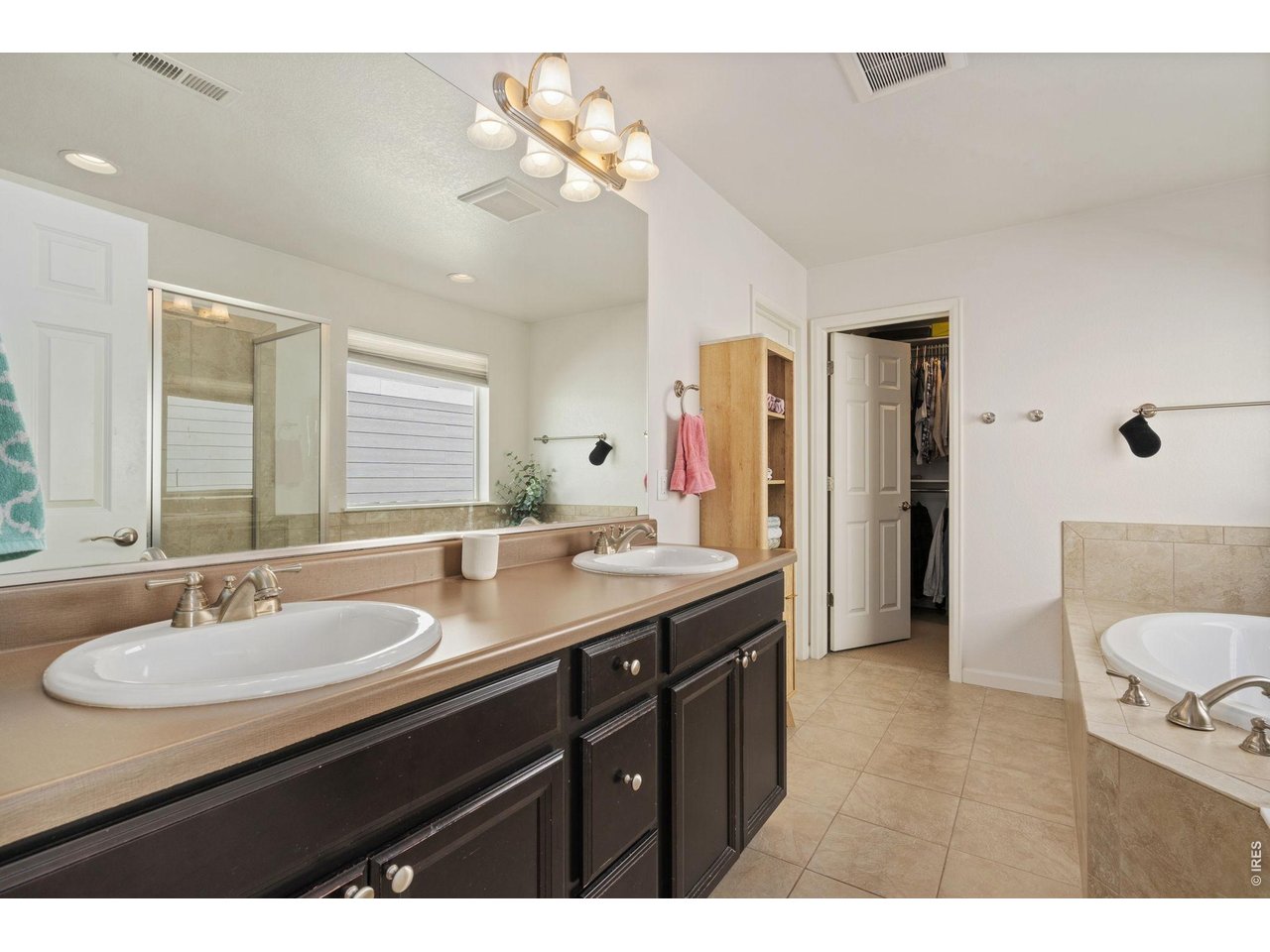 Thoughtfully designed for everyday living, this inviting two-story home offers comfort, space, and style in every detail. From the welcoming covered front porch, step inside to beautiful wood floors and an open main level filled with natural light. The great room features soaring ceilings, built-in shelving, and a cozy gas fireplace that makes the perfect gathering spot. The kitchen opens easily to the living and dining areas, as well as the back patio-ideal for family time or entertaining friends. A main-floor office provides a quiet spot to work from home or enjoy hobbies and crafts. Upstairs, the primary suite includes a spacious walk-in closet and a relaxing five-piece bath with a soaking tub and separate shower. The second bedroom has its own en-suite bathroom, while two additional bedrooms with walk-in closets share a full bath with a double-sink vanity. The laundry room is conveniently located on the same level. The oversized two-car garage-with an 8-foot door-offers plenty of room for vehicles and storage. A large unfinished basement adds extra space and future potential. Outside, the fully fenced backyard is perfect for kids, pets, and playtime. Enjoy the great trails throughout the neighborhood! Conveniently located near schools, parks, and shopping, this home is the perfect blend of comfort, function, and everyday family living.