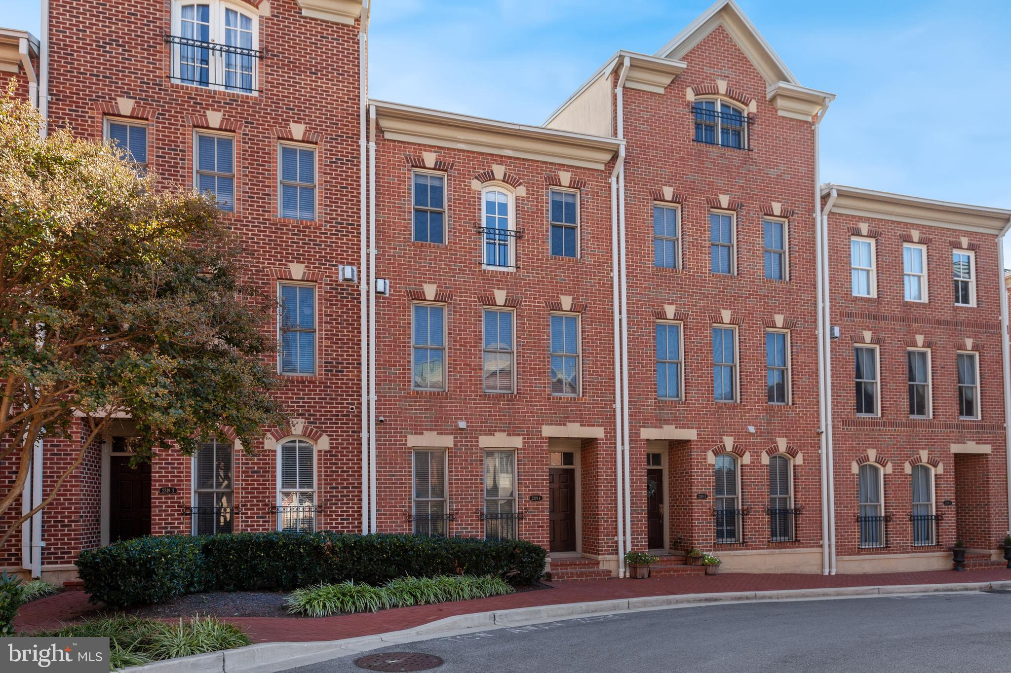 Experience refined city living in this luxury three-level townhome located in the highly sought-after North Shore community of Canton. Perfectly positioned in an ideal, walkable location, this home is just steps from popular restaurants, boutique shops, waterfront promenades, and neighborhood parks.Inside, you’ll find a thoughtfully designed layout featuring a gourmet kitchen with rich cherry cabinetry, granite countertops,  gas cooking, stainless steel refrigerator, island with breakfast bar and seamlessly opening to an outdoor balcony ideal for morning coffee or evening unwinding. Elegant hardwood floors, 9-foot ceilings, and a cozy gas fireplace with mantle enhance the main living areas with warmth and sophistication.The spacious primary suite offers a relaxing retreat complete with a large en-suite bath with double sink vanity and soaking garden tub.  An additional fairly sized bedroom and full bath with tub/shower combo completes the upper level. A first-floor bedroom provides flexibility for guests, a home office, playroom, or multigenerational living.Additional highlights include an all-brick exterior, two-car garage, and two additional driveway parking spaces, offering rare and convenient parking in the city. Set within a water-oriented community, this exceptional townhome blends luxury, comfort, and unbeatable Canton convenience.