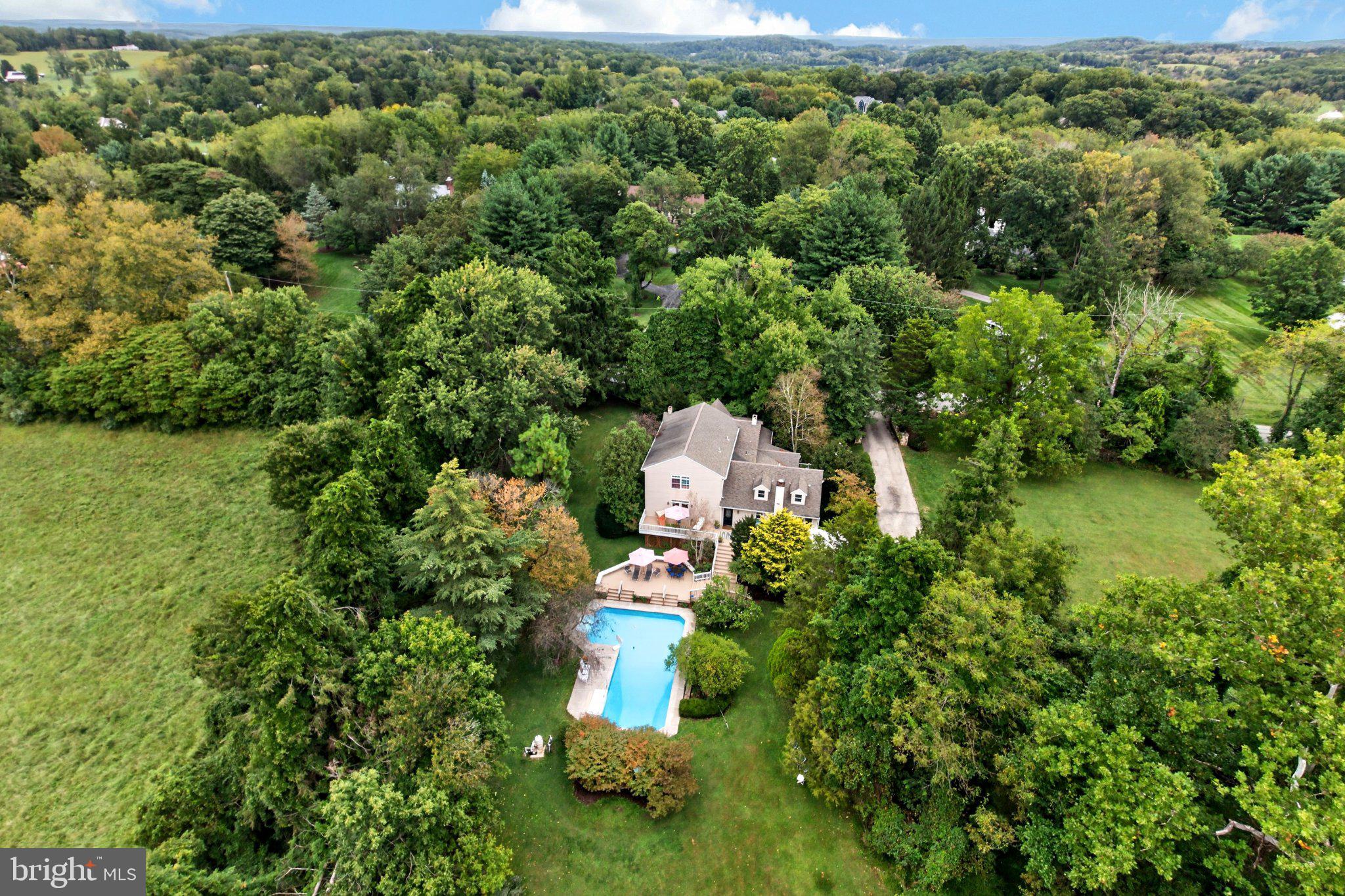 Welcome to 1043 Bodine Rd situated in the heart of Chester Springs, one of Chester County's most recognized and desirable towns! The wait for an expanded Cape Cod full of character in the award-winning Downingtown Area School District is finally over! Deeply rooted in historic Chester Springs, this property dates back to the early 1900's and sits on 1.6 acres, offering unparalleled seclusion and privacy in a rural, country setting just minutes from Main Line suburban living. Surrounded by multi-million dollar estates, 1043 Bodine has a combination of old-world charm and modern features for everyday living. A handsome stonewall lined drive welcomes you onto the property where you are greeted by mature landscaping, stunning views and open green space. Take note of the convenient side entrance with a paver walkway to the charming covered stonefront entry. Prepare to be wowed by the inside! Gorgeous hardwoods, expansive millwork, exposed wood beams, built-ins and recessed lighting are just some of the many features! The main level is highlighted by the primary suite, updated kitchen and sunken family room. The country, eat-in kitchen is a cook's dream with double wall oven, gas cooking, updated counters, large island with prep sink and barstool seating and large sunny breakfast area. The massive family room features a gas fireplace and french door access to the rear deck. Step into the large primary suite and unwind! It features a wood-burning fireplace, vaulted ceiling with fan, skylights and an abundance of natural light. The primary bath offers a large tile walk-in shower, soaking tub and separate water closet. This level is completed by the formal living and dining rooms, mudroom, laundry and a full bath. Upstairs features three generously sized bedrooms, one with an en-suite bath, and a full hall bath. Looking for outdoor space? This property offers the perfect staycation retreat! The massive upper level deck features a gazebo and steps to the lower pool deck. The huge in-ground pool and the lush green flat backyard offer maximum space to entertain and enjoy year round! Need more value? The detached barn provides covered parking and storage. The shed provides room for all of your landscaping and gardening tools and additional storage. With quick access to routes 401, 113, 76 and 100, you can get anywhere fast. Equidistant to vibrant Phoenixville and Malvern Boroughs, the Main Line is a short drive away, and endless shopping and dining options in Exton and Downingtown. Many parks and country clubs are nearby too. This type of property does not come around often! It must be seen in person to fully appreciate all that it has to offer! Schedule your tour today! 