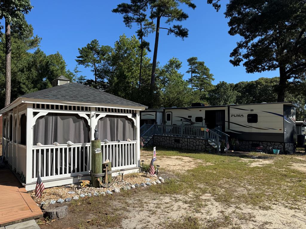 Two lots with newer camper.  Camper has two bedrooms and one and one half bathrooms.  Two sheds on site.  Large detached screen room.  Great package deal.  Lots of potential for expansion.  Includes access to pool, dock, fishing pier, crabbing pier, marina, clubhouse, boat ramp, boat slips, pavilion, playground, and more.