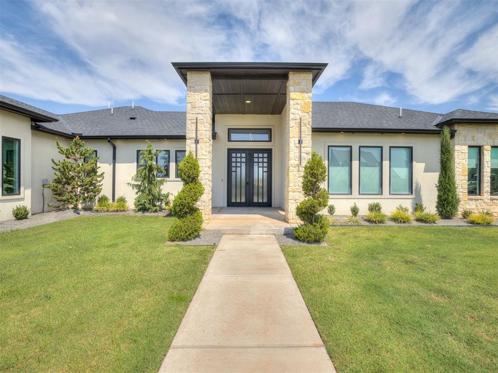 Set on a picturesque 1.09 acres in gated Addington Farms, this exceptional 4,048-square-foot luxury home in Edmond combines sophisticated design, impressive scale, and flexible spaces for everyday living & entertaining. With 4 Bedrooms, 2 living areas, 2 office areas, and 3.5 bathrooms- it has it all! Located in the highly sought-after Deer Creek School District, the home welcomes you with soaring ceilings, abundant natural light, and an expansive living room anchored by a floor-to-ceiling fireplace & custom built-ins. The chef-inspired kitchen features an oversized island, beautiful countertops, abundant cabinetry, double built-in ovens, and a spacious walk-in pantry. The cooktop area is also plumbed for gas, providing added flexibility. An adjoining dining area flows seamlessly to the covered patio and outdoor living spaces. The spacious primary suite showcases custom ceiling details and a beautifully appointed bath with dual vanities, a steam-equipped walk-in sauna shower, and an impressive custom closet. Three additional bedrooms with walk-in closets are privately positioned in a separate wing, including one featuring an ensuite bath. A dedicated home office & two versatile bonus rooms offer space for a media room, home gym, hobbies, playroom, or content studio. A separate exterior entrance creates an ideal option for a private studio, workspace, or home-based business. Designed for Oklahoma outdoor living, the backyard features a built-in grill, cozy fire pit, dedicated hot tub hookup, and generous covered patio. Additional highlights include an oversized three-car garage, storm shelter, water softener, large utility room, and thoughtfully selected finishes throughout. This gated Edmond acreage property delivers luxury, versatility, & Deer Creek Schools in one unforgettable home. Schedule your private showing today!