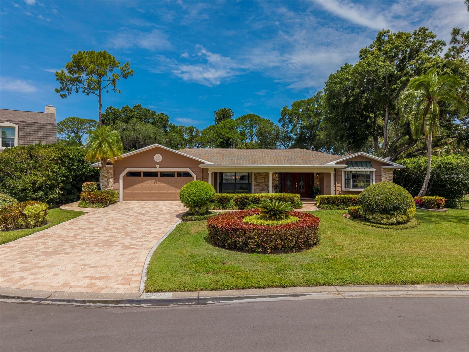 Welcome to this exceptional 4-bedroom, 4-bathroom pool home nestled on a nearly 1/3-acre oversized cul-de-sac lot in the highly desirable Feather Sound Country Club community. Offering timeless elegance, spacious living areas, and outstanding updates, this residence showcases pride of ownership throughout. As you arrive, you'll be impressed by the stunning curb appeal featuring lush tropical landscaping, a paver driveway, a grand covered front porch, and an inviting double-door entry. Situated on one of the community's elevated lots, the home remained high and dry with no flooding during the 2024 storms, providing valuable peace of mind.Designed for both everyday living and entertaining, the heart of the home is the beautifully appointed kitchen featuring granite countertops, real wood cabinetry, stainless steel appliances, built-in ovens, and an induction cooktop. The thoughtful floor plan flows seamlessly into multiple living spaces, including formal living and family rooms, each enhanced by a cozy gas fireplace and an enclosed Sunroom .Step outside to your private backyard retreat where a gorgeous saltwater pool with PebbleTec finish is surrounded by mature landscaping and expansive outdoor living space, creating the perfect setting for relaxation or entertaining family and friends.The spacious primary suite serves as a true sanctuary, complete with a luxurious bath featuring a sunken soaking tub, shower combination, and a skylight that fills the space with natural light. The home offers exceptional flexibility with three ensuite bathrooms throughout, including an oversized secondary primary suite featuring a large walk-in closet and elegant French doors that open directly to the pool and backyard. Additional features include an interior laundry room conveniently located off the two-car garage, a security system, water softener, and numerous major system updates. The roof was replaced in 2012, the two-zone HVAC systems were replaced in 2014 and 2021, and both the water heater and pool pump are approximately three years old. Residents enjoy access to the renowned Feather Sound Country Club, which offers an 18-hole championship golf course, tennis facilities, social memberships, clubhouse pool, dining venues, and event spaces available for weddings and special occasions. Memberships are available but optional, and notably, the community has no HOA fees. Feather Sound is known for its beautifully maintained green spaces, scenic bike trails, parks, and welcoming atmosphere. Conveniently located near I-275, you'll enjoy easy access to Tampa, Downtown St. Petersburg, Tampa International Airport, and Pinellas County's world-renowned Gulf beaches. Shopping, dining, and everyday conveniences are all just minutes away. This remarkable home combines space, comfort, quality updates, and an unbeatable location. Don't miss your opportunity to make this beautiful Feather Sound family home your own.