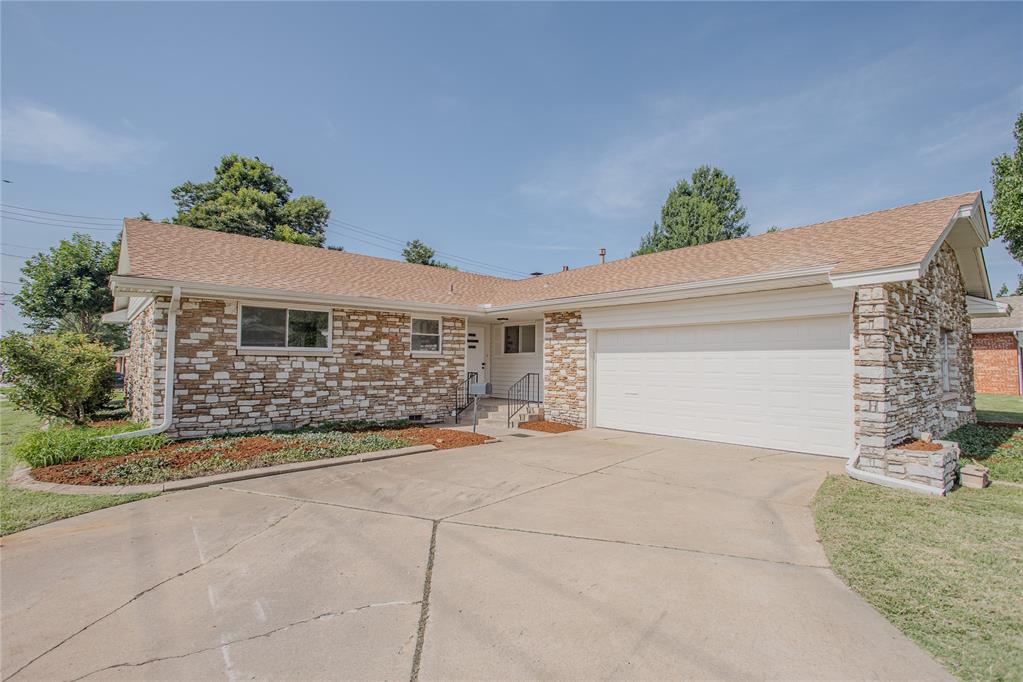 Welcome to this beautifully updated and move-in-ready home, perfectly situated in the desirable Putnam City School District. Offering a fantastic blend of timeless charm and modern finishes, this 3-bedroom, 2-bathroom residence is waiting for you to call it home.

Step inside to the spacious and inviting main living area, where you'll be greeted by stunning original hardwood floors that gleam in the natural light. A handsome fireplace serves as the cozy centerpiece of the room, perfect for relaxing evenings. The open layout is enhanced by a pass-through to the kitchen, creating an ideal flow for entertaining and everyday living.

The bright and airy kitchen has been thoughtfully updated with brand-new, stylish marble-look tile flooring. It features crisp white cabinetry with modern hardware, ample counter space, a sleek cooktop, and stainless steel wall oven and dishwasher.

Retreat to the comfortable bedrooms, all featuring plush new carpeting underfoot. The home boasts two updated bathrooms with fresh, clean aesthetics. You'll love the modern vanities, new fixtures, and beautiful tile work, including classic hexagonal tiles in one and coordinating marble-look tile in the other.

The home's exterior is just as appealing, with attractive stone accents that provide wonderful curb appeal. The attached two-car garage offers convenience and extra storage. In the back, you'll find a private, fenced-in yard with a covered patio—the perfect spot for summer barbecues, morning coffee, or simply unwinding.

With its significant updates and prime location, this is a fantastic opportunity you don't want to miss. Schedule your private showing today!