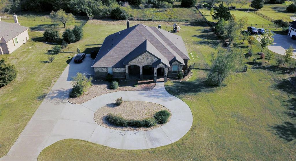 Gorgeous single story 5 Bedroom Home in Rockwall's High Point Estates on 1.5 acres with NO MUD, NO PID, NO CITY TAXES!! Located in a peaceful deer grazing Country setting, yet so close to City amenities! No Houses directly behind with additional rear acreage and endless possibilities including adding a Guest House, Work Shop or Pool with a surrounding Oasis! Over 2,990 sq ft of fabulous living space, loaded with custom features!! Large Gourmet Kitchen with an abundance of crown topped Knotty Alder Cabinets, Butler's Pantry-optional Dry Bar with built-in Wine Rack, Granite Countertops, stainless steel Appliances, double convection ovens, 5 burner gas cooktop, wide wrap around Breakfast Bar and center Island. Spacious Dining and Living with corner floor to ceiling gas log stone Fireplace. Mud Room and oversized Laundry with Cabinets and Drip Dry Rod. Extensive crown moulding and wood look tile in entry, main living areas, Laundry and Baths. Front Office-optional 5th Bedroom with double French Doors and two closets. Split Bedroom arrangement with large private Owner's Suite, Bay Window, En-suite Bath with two Granite topped vanities, linen closet, oversized rimless shower, jetted Garden Tub, chandelier, triple racked walk-in closet system, floor to ceiling storage bins plus a secret room for added storage. Media Room with 7.1 surround sound, sub-woofer and ceiling speakers. Ceiling speakers also in Living, Primary Bedroom and back Patio. Front circular drive with side swing 3 Car Garage, full House Water Softener and two tankless water heaters. Large covered back Patio with built-in Grill, gas starter Stone Fireplace, side Granite topped Serving Bar plus extra side gas tap. Sprinkler system, garage granite topped storage cabinets and more! Access to near by pond, walking trails and pavilion.