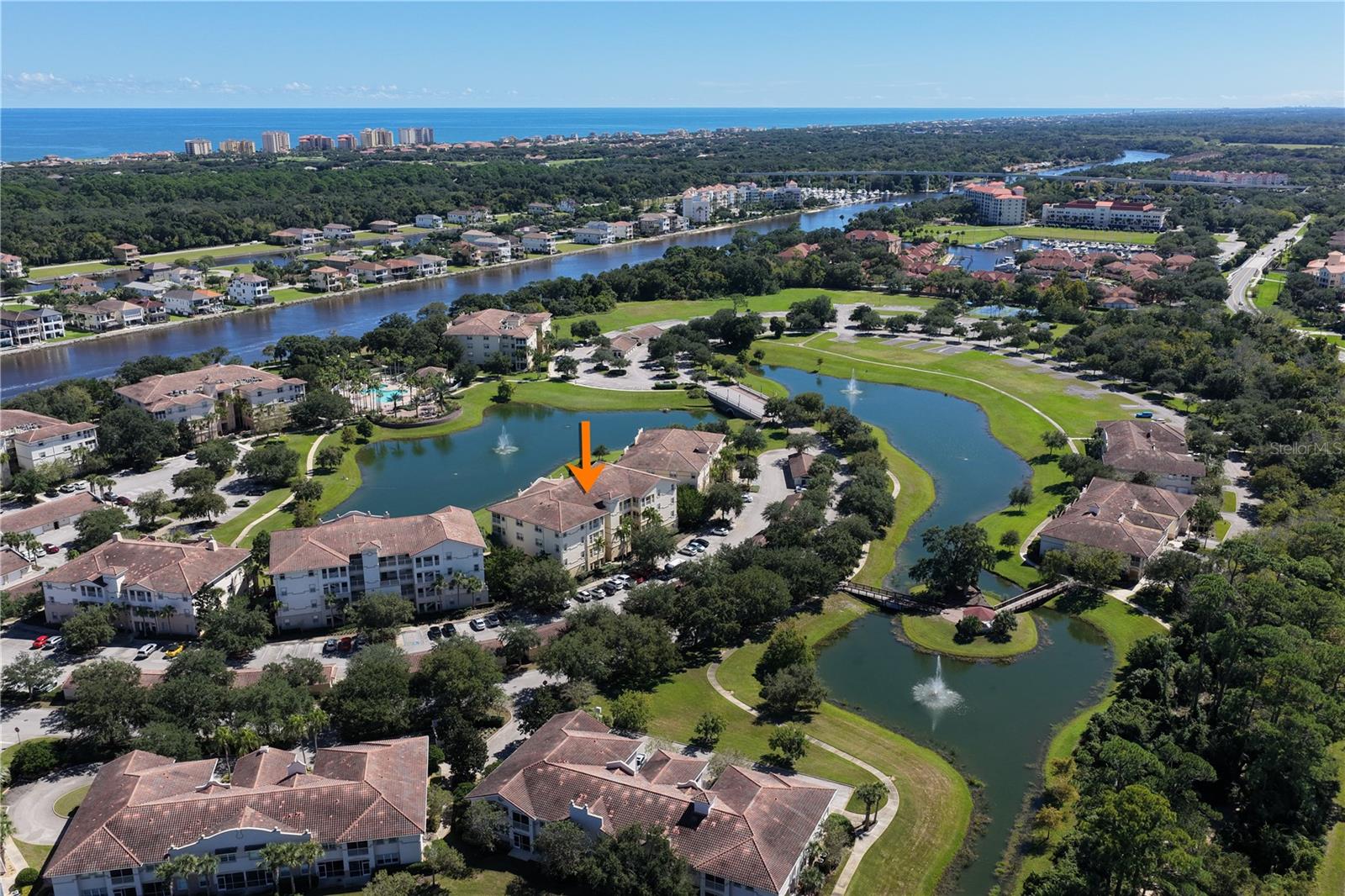 LAKEFRONT LIVING, MORNING SUNRISES & EASY GROUND-FLOOR ACCESS! Welcome to 85 Riverview Bend S, Unit 1513, where views of Tidelands’ main lake and fountain draw you in from the moment you open the door. This 2-bedroom, 2-bath split-plan condo invites you to slow down, settle in, and enjoy the view—with a covered, screened lanai offering direct walk-out access to the lakeside path. An easy front entry with a built-in screen welcomes refreshing cross-breezes. Inside, the open layout connects the kitchen, dining, and living areas, keeping the water in sight and conversation flowing. White wood cabinetry, black granite countertops, a breakfast counter, and two entry points make the kitchen equally inviting for everyday living and entertaining. Plantation shutters fold aside, and triple sliding glass doors open to extend your living space onto the lanai. Wake to eastern morning light and fountain views from the primary suite, then step through your private sliders to enjoy your morning coffee outdoors. The suite includes a walk-in closet, an additional closet, and an ensuite bath with a shower, double vanities, and linen storage. Across the condo, the guest bedroom offers room for a bed, nightstands, and a desk, with a full bath just outside. A separate utility room off the kitchen includes a full-size washer and dryer. From your lanai, step onto the path for a stroll beside the lake or head toward the Intracoastal pool, barbecue areas, covered pavilion, and tennis/pickleball courts. Beyond your doorstep, discover what makes Tidelands so special: a gated, pet-friendly community with mature landscaping, underground utilities, illuminated paths, and miles of walking and biking routes, including scenic stretches along the Intracoastal Waterway. Community amenities include a clubhouse, a separate clubhouse pool heated year-round, fitness facilities, game and billiards rooms, onsite management, and a maintenance team caring for the community grounds. Watch boats and rowers glide by, look for dolphins and manatees, or spend time fishing along the waterfront. Nearby European Village offers restaurants and a Sunday farmers market, while Jungle Hut Beach is a short drive across the Hammock Dunes Bridge. From sunrise on your lanai to an evening waterfront stroll, this is a home that brings the Tidelands lifestyle right to your door. Welcome home.