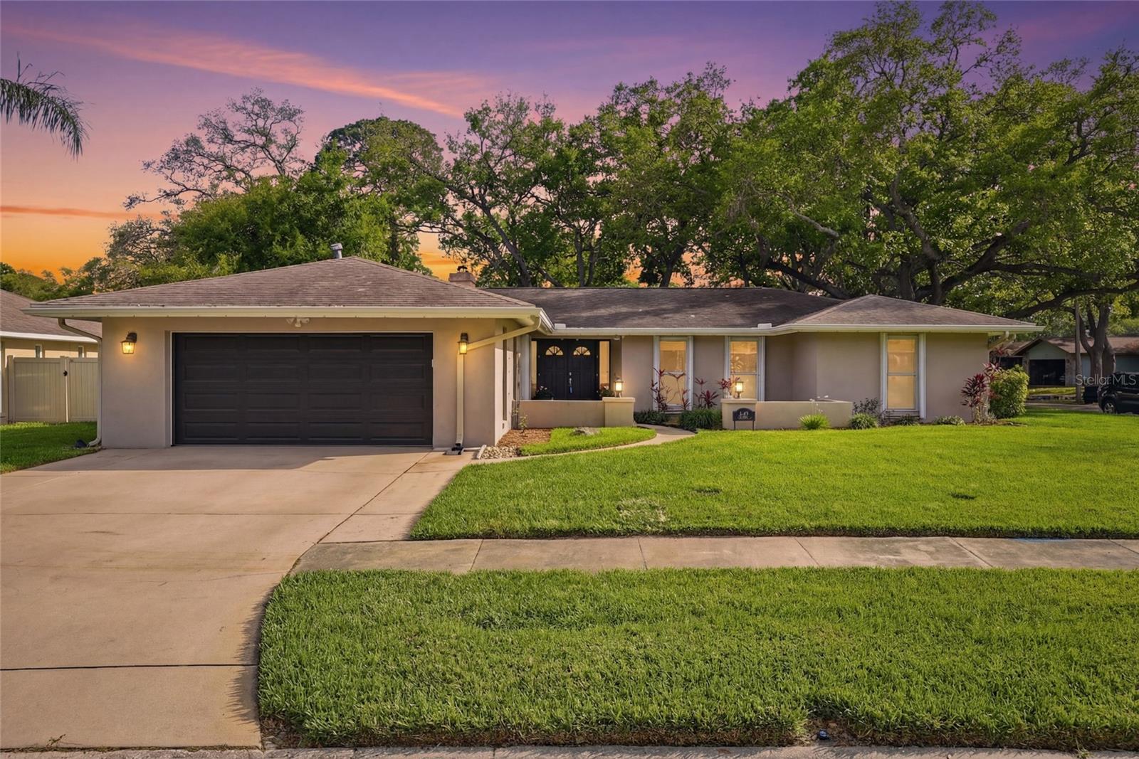 Welcome to this beautifully maintained four-bedroom, three-bath pool home located in the heart of Pinellas County in the highly desirable Brookside neighborhood, where comfort, style and Florida living come together perfectly. From the moment you arrive, you'll be captivated by the gorgeous landscaping and impressive curb appeal, giving the home a warm and inviting presence. Step inside to a spacious, open, and bright floorplan designed for both comfortable everyday living and effortless entertaining. The layout flows perfectly between the kitchen, dining and living spaces, allowing everyone to stay connected while still offering defined areas to gather and relax. Large windows fill the home with natural light and offer views of the pool and backyard, creating a bright and welcoming feel throughout.  The well-appointed kitchen offers a pass-through, generous counter space, and abundant cabinets, with plenty of room to cook, entertain and gather with family and friends. Enjoy the flexibility of two separate living areas, perfect for a family room, formal living space, media or entertainment space. A wood-burning fireplace adds warmth and charm, creating a cozy focal point in the home.  One of this home's many highlights is the separate in-law suite, complete with its own bathroom and a door leading to the pool area. This offers an opportunity for multi-generational living, extended family, guests or even a private home office. This unique feature provides both convenience and privacy while still being connected to the main home.  The split-bedroom floorplan enhances privacy throughout the home. The nicely sized bedrooms are designed for comfort and have ample closet space. You will be greeted with quality wood-look porcelain tile in the bedrooms and bathrooms, offering durability and elegant style. The primary suite is retreat-like, offering generous space that creates a relaxing atmosphere. The primary bedroom also boasts multiple closets and an ensuite featuring a large vanity, storage, and a large sunken shower. The perfect place to start and end your day.  Head out to your own private Florida oasis, featuring a large sparkling pool perfect for sunny Florida days. Read a book, enjoy a cup of coffee or host a gathering, either way this backyard will accommodate any of them. The beautifully maintained yard includes natural landscaping, a newer vinyl fence and underground drainage designed to keep the home well-maintained year-round.  Located in a wonderful neighborhood known for its community gatherings, this property also offers a prime central Pinellas location, placing you minutes from the award-winning Gulf beaches, parks, boating, golfing, dining, shopping and endless activities. This home truly offers the perfect blend of space, functionality and the true Florida lifestyle. Pride of ownership shows. Come see it today.