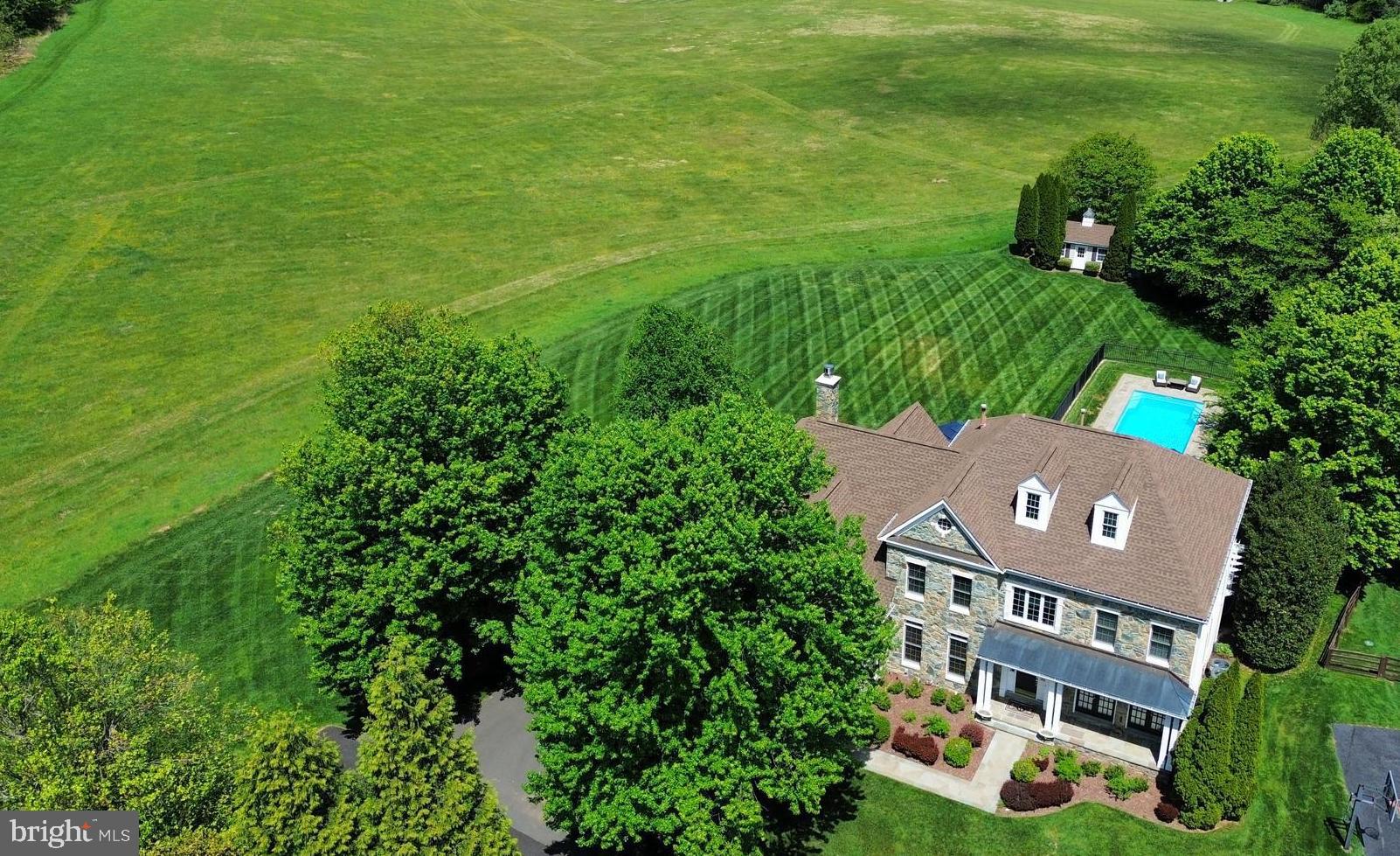 Set on one of the most coveted and private homesites in Lenah Run, this estate home offers a rare combination of privacy, scale, and refined outdoor living with beautiful decks, flagstone patios and an inviting pool!  Over 6,000 square feet of interior living space offers plenty of room to entertain Privately positioned at the end of a quiet cul-de-sac, this residence is sited on one of the community’s most picturesque lots, backing to protected conservation land and offering a serene, uninterrupted natural backdrop.A handsome stone exterior, paired with a covered front porch featuring a standing seam metal roof and flagstone entry, introduces the home with timeless architectural presence.The outdoor living experience is exceptional. Thoughtfully designed for both intimate relaxation and large-scale entertaining, the property features multiple elevated decks, expansive flagstone terraces, and a beautiful pool—all overlooking beautifully landscaped grounds and the surrounding conservation area. The result is a setting of remarkable privacy and quiet sophistication.Inside, a light-filled two-story foyer sets the tone, complemented by a flowing floor plan designed for both everyday living and formal entertaining with over 6,000 square feet. A private main-level library offers an ideal work-from-home environment, while the formal living and dining rooms provide refined spaces for hosting.The gourmet kitchen is appointed with abundant cabinetry, stone countertops, and stainless steel appliances, and opens seamlessly to a sunroom wrapped in windows—capturing sweeping views of the pool and natural landscape beyond. The adjacent two-story family room features a wood-burning fireplace and  dramatic wall of windows to take in the views.  The upper level is anchored by a spacious primary suite with a private sitting area and dual walk-in closets, along with a well-appointed bath featuring separate vanities, a soaking tub, separate shower, and enclosed water closet.  A large princess suite offers its own ensuite bathroom and walk-in closet, while two additional generously sized bedrooms share an additional third full bath. The walk-out lower level offers substantial flexibility to create your perfect informal living spaces—whether a media room or fitness studio, plus a guest suite with 4th full bath—while still maintaining generous open recreation space.Homes with this combination of setting, privacy, and outdoor living are a rare find in Aldie. This is a great opportunity to own such a home in one of Loudoun County’s most desirable communities.Lenah Run is a hamlet-style enclave distinguished by estate homes on expansive homesites, thoughtfully framed by HOA-owned conservation land—creating a setting defined by open space, natural beauty, and enduring privacy. Residents enjoy a resort-caliber pool,  basketball courts, a children's playground, scenic walking trails, and a well-curated calendar of community events. Professional photos are coming soon!