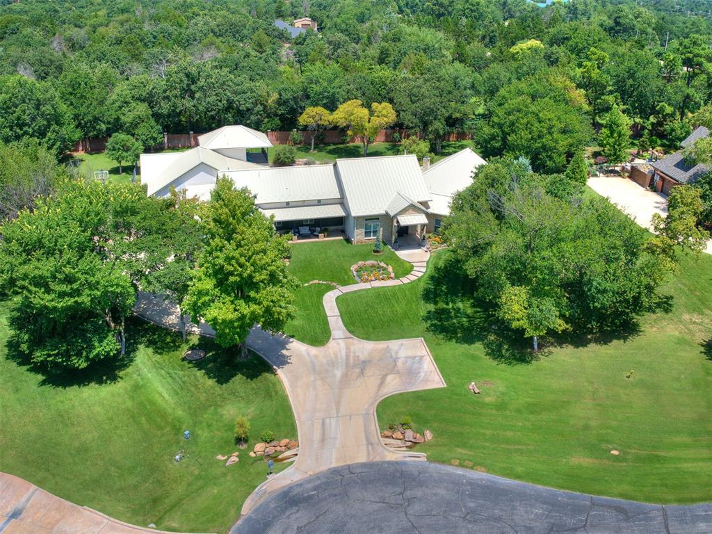 Relaxing, Beautiful & Functional are words that best describe this Texas Hill Country architectural home, with a pristine pool & amazing outdoor spaces. Set on a wooded lot in the gated neighborhood of Oakdale Farm, this property has everything you could ever hope for, starting with a perfect floor plan with everything on 1 level + 1 bedroom up, a glorious kitchen with 2 islands, & a game room conveniently accessible from the kitchen & living room. The large kitchen, with granite countertops is equipped for entertaining, with a full size side-by-side fridge/freezer, 5 burner induction range, double oven, ice maker, 2 sinks & a walk-in pantry. The living room, with a masonry fireplace & cathedral beamed ceiling, is a tranquil space filled with natural light that filters in from a wall of windows & clearstory windows above. In a secluded wing of the home is the large primary suite with gas thermostat-controlled fireplace & a gorgeous bathroom with double vanities, walk-in shower, soaking tub & a spacious walk-in closet. An exercise room and safe room are in the adjoining hallway. A workstation desk with sliding glass doors, located next to the kitchen and an executive study with bar are great "work from home" spaces. The west wing of the home includes 4 bedrooms, each with its own full-size bathroom and walk-in closet. A serene resort experience is found in the backyard while relaxing under the expansive covered patio area, or in the screened patio with fireplace, or while cozying upto the firepit & cooking in the outdoor kitchen with ice maker, fridge, sink, grill, 2- burner range, warming drawer & built-in ice chest. The crystal blue pool with waterfalls & spa completes the resort experience, with a beach entry into 3'to11' depths & has a heated Pentair IntelliChem Pool system. Plenty of room for guests to park in the double-wide driveway with parking spaces & over-sized 4-car garages. New standing seam metal roof in 2024. Come see this dream home soon!