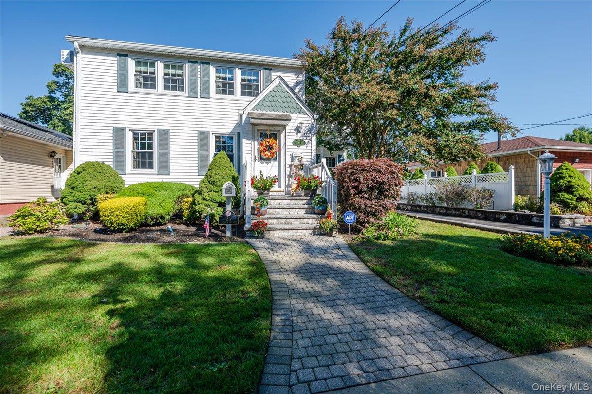 Welcome to this beautifully maintained Colonial-style home that truly has it all!  Nestled in the heart of sought-after Bethpage, this spacious 4-bedroom, 3-bathroom gem offers incredible curb appeal and a warm, inviting atmosphere from the moment you arrive.  Step inside to an open floor plan, featuring a bright and airy kitchen with vaulted ceilings, a huge center island, and abundant natural light.  The kitchen flows seamlessly into a cozy den with fireplace, accented by skylights and stunning cedar wood vaulted ceilings that add warmth and character.  Throughout the home, you’ll find hardwood and laminate flooring, custom woodwork, and thoughtful finishes that blend timeless style with modern comfort.  The primary suite is a peaceful retreat with an en suite bath featuring a jacuzzi tub.  Flexible living space and plenty of storage.  Step outside and enjoy your own oasis, a custom Trex deck with built-in seating and planters, overlooking a maintenance-free turf lawn – year-round enjoyment and effortless outdoor living.  Updates in last 6 years: windows and patio slider door, roof, driveway with beautiful stonework.  Truly a must-see!