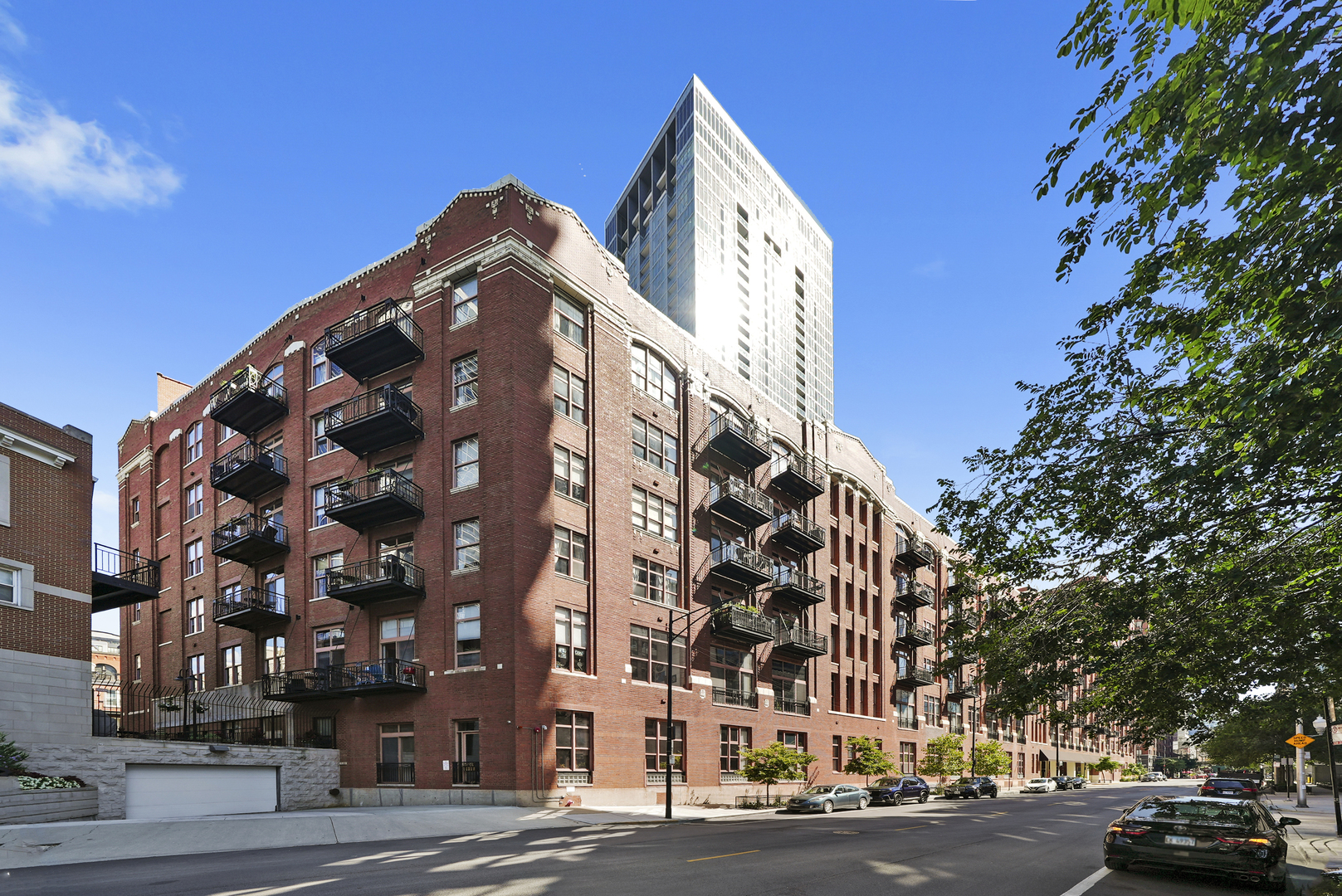 Rarely Available 2 Bed / 2 Bath Duplex Penthouse with Private Terrace  Truly unique residence at the Sexton Lofts in premier River North. This two-level penthouse showcases soaring ceilings, exposed brick & timber, hardwood floors, and in-unit laundry. Main floor offers an open kitchen with quartz counters & stainless appliances, spacious dining/living area with fireplace, and balcony. Upstairs, the oversized primary suite features a custom walk-in closet, spa-inspired bath, office/fitness nook, and private balcony. Enjoy a 26'x12' private roof terrace with skyline views. Amenities include fitness center, sundeck, bike room, door staff & more. Heated garage parking available.