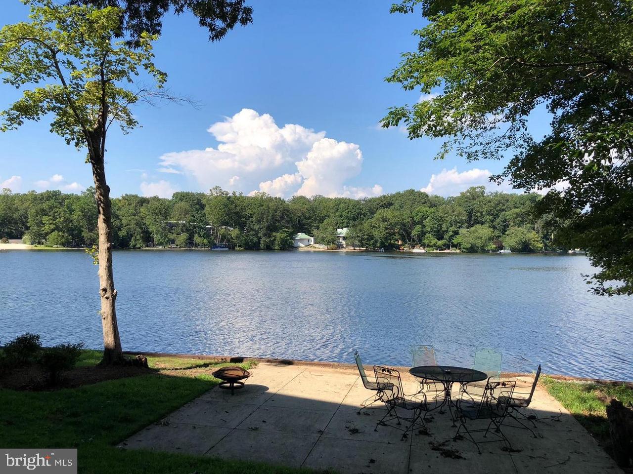 Rare opportunity to purchase a premier lakefront home in coveted Lake Barcroft, offering breathtaking views, a tranquil setting, and a true resort-style lifestyle—just 7 miles from Washington, D.C. Perfectly positioned at water level on one of the lake’s widest and deepest sections, this exceptional property enjoys uninterrupted vistas and an intimate connection to the water rarely found this close to the city.The home features nearly 5,000 finished square feet across three fully finished levels, with floor-to-ceiling picture windows on every level and stunning lake views from nearly every room. Multiple decks and balconies create seamless indoor-outdoor living and ideal spaces for entertaining or quiet relaxation.Highlights include hardwood floors on the main level, an open kitchen with granite countertops, marble-tiled primary bath, skylights, and generous living and entertaining spaces throughout.Residents enjoy access to a private 135-acre lake with five beaches, offering swimming, kayaking, boating, and year-round recreation, all with a low annual fee of just $495.A true commuter’s dream with easy access to Routes 244 and 7, I-495, I-395, Express Lanes, and other major routes—plus minutes to D.C., shopping, dining, and everyday conveniences. This is lakefront living at its finest, combining serenity, views, and an unbeatable location.Open Saturday January 17, 2-4 pm.  Interior photos will be loaded Friday Jan 16.  Showings begin Friday at 12 noon