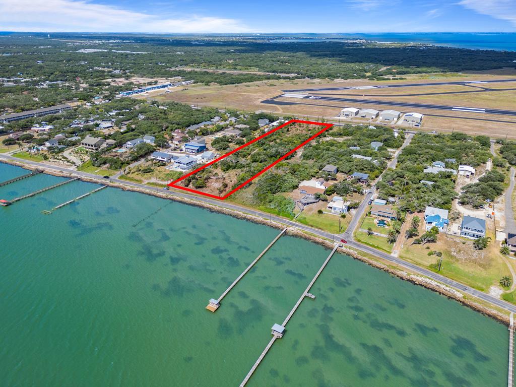 3.7AC of Prime Waterfront Acreage in Fulton, TX – A Rare Opportunity Awaits! Discover 3.7 acres of unmatched potential in the heart of Fulton, Texas—where the land meets the water, and your vision can become reality. This exceptional waterfront property offers dual frontage along both Highway 35 and the highly sought-after Fulton Beach Road, placing you at the crossroads of visibility, accessibility, and coastal charm. Whether you're a developer with big plans or a dreamer searching for a coastal retreat, this versatile property invites endless possibilities.  Let your imagination roam—panoramic water views, steady Gulf breezes, and mature coastal foliage set the stage for a truly unique investment. The location provides not only stunning scenery but also unbeatable convenience, with nearby shops, dining, and the vibrant energy of Rockport-Fulton just minutes away. Don't miss this rare chance to claim one of the last large parcels of waterfront land in one of South Texas's most desirable coastal communities. This is more than land—it's opportunity, location, and lifestyle in one.