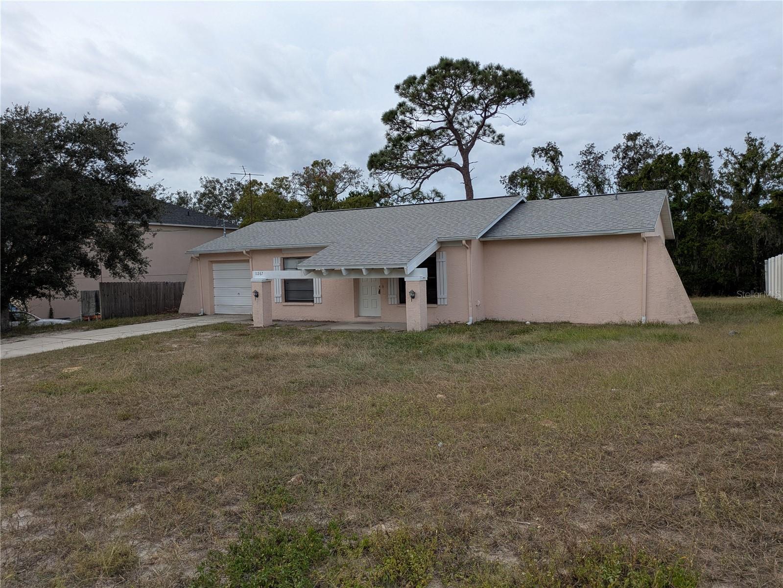 Delightful two bedroom two bath home on conservation lot in Spring Hill is now available at an affordable price!  This charming home features a BRAND NEW ROOF, a great layout with a split bedroom design, an open floor plan & a large one car garage.   The spacious backyard is partially fenced offering privacy and is perfect for get togethers & outdoor cook-outs.  This Fixer Upper is waiting for your personal touch to update and make it your own.  Conveniently located near major roads, restaurants & shopping areas. This home is a budget friendly option with no CCD's or HOA fees.  Come see today!
