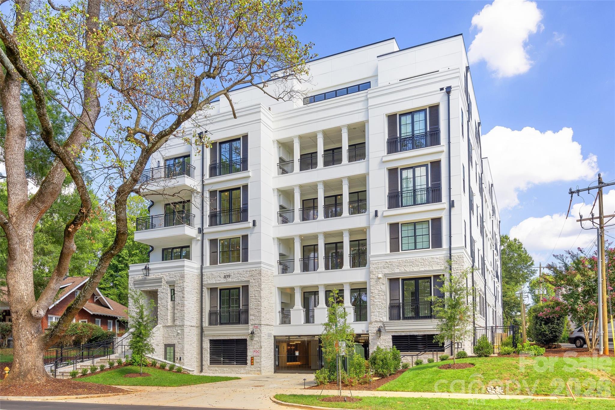 Exceptional penthouse located within 409 Queens, an exclusive 17-residence boutique condominium community built by Copper Builders along tree-lined Queens Road in Myers Park. One of just two penthouses occupying the top floor, this exquisite residence offers 4,470 square feet with expansive living spaces and abundant natural light. Open-concept living and dining areas feature hardwood floors, soaring ceilings, a gas fireplace and floor-to-ceiling glass doors opening to an expansive private rooftop terrace with built-in grill and beautiful city and tree canopy views. The beautifully appointed kitchen features custom cabinetry, gleaming countertops, oversized island and premium Wolf, Sub-Zero and Asko appliances. A wine room, den/morning room and private office add versatility, while the primary suite opens directly to the terrace and features a separate flex room, expansive custom closet and spa-like bath. Two additional en-suite bedrooms, dedicated laundry and two deeded parking spaces in the secure garage complete the residence. Curated building amenities include a resident club room with fireplace, covered outdoor patio, fitness center and wine storage. Ideally situated minutes from Uptown, SouthPark and the shops and dining of Myers Park, 409 Queens offers sophisticated, lock-and-leave living in one of Charlotte’s most desirable locations.