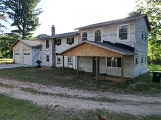 2700 Square foot home on 80 acres.  This 4 bedroom 3 full bath home is waiting for your finishing touches.  All new mechanicals done in 2024.  New Well, septic and drain field in 2022.  2 Stall attached garage along with mud room and pantry has in floor heating installed but needs to be hooked up.  Approach has what is considered snow melt as well.   New windows and doors were installed in 2024.  New 200 AMP Electrical service done is 2022.    New roof in 2023.  There is approximately 7 acres of fenced in pasture on the west side of the property with electric fencing.  10 acres on the east side of the property was clear cut.  Wood shop has in floor heat with storage space in the attic.  Green house is stunning.  4 food plots are located on the property.