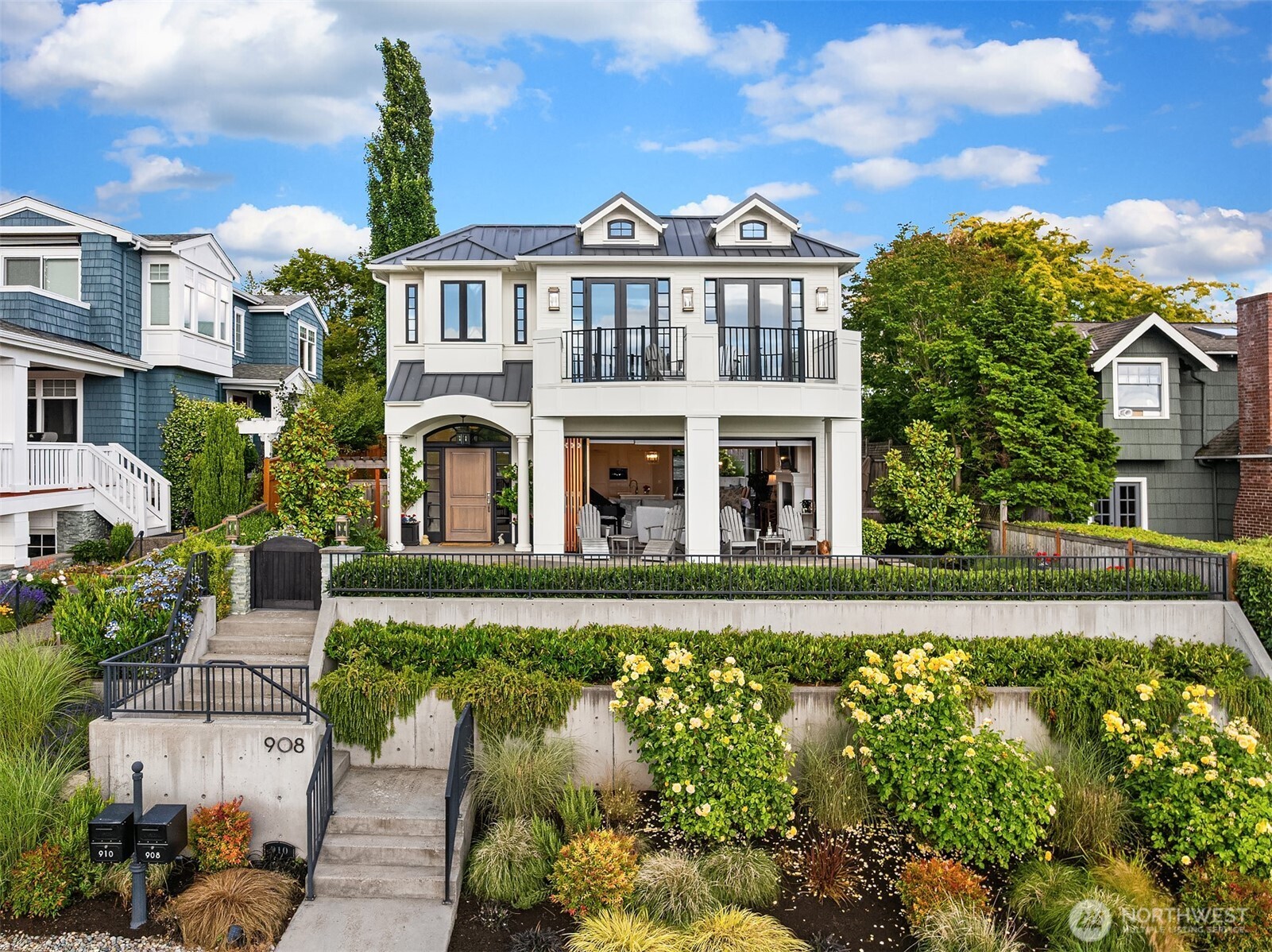 After falling in love with a coastal California home where the walls opened to the sea and the line between inside and out all but disappeared, the owners set out to bring that same inspiration home to the Northwest. The result is a home that marries indoor/outdoor living with the lake and mountains and Seattle as the backdrop. Dream kitchen features custom cabinetry+hidden walk-in pantry+slab quartz surfaces+Miele appliances+entertaining island+built-in espresso machine. LaCantina accordion doors deliver on the original California folding away entirely so the great room and terrace become one. Great Room enhanced by 10' ceilings+hand-stained French oak flooring+custom millwork+designer lighting+built-in Sonos audio throughout. Primary Bedroom w/view balcony+fireplace+spa-inspired bath+custom walk-in closet. 2 Additional ensuite bedrooms and 3rd bed/office complete the 2nd floor. The lower level is an entertainer's world-complete with state-of-the-art theater featuring a 120" projection screen+integrated sound system+spacious+bar area. Year-round outdoor living w/heated covered patios+fireplace+spa+BBQ+landscape lighting infrastructure, raised garden beds, and fully fenced grounds.  Adding exceptional versatility and investment potential, the property includes a private, fully equipped ADU featuring its own entrance, parking space, balcony w/lake views+full kitchen+laundry+living room+bedroom and bath. Blocks from Kirkland's vibrant waterfront, restaurants, parks and marina.