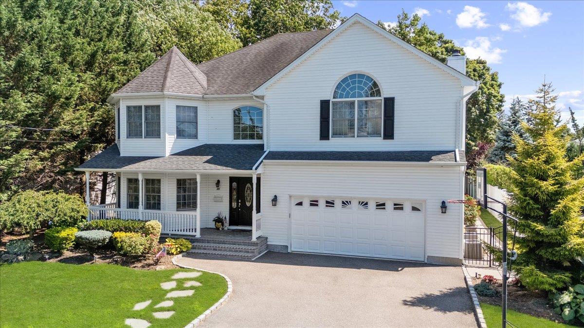 Welcome to this magnificent 4,000 sq ft Colonial, built in 2005, nestled on an oversized 11,800 sq ft lot in the heart of Bethpage. This 5-bedroom, 2.5-bathroom masterpiece blends timeless elegance with modern functionality, perfect for families seeking luxury and convenience. Step into the grand double-height entry foyer, where high ceilings and custom base/crown moldings set a sophisticated tone. The first floor boasts a spacious living room, formal dining room, and a gourmet kitchen with a center island and cozy breakfast nook. The expansive family room, featuring a wood-burning fireplace and exquisite coffered ceilings with custom woodwork, is ideal for gatherings. A convenient powder room completes this level. Upstairs, the massive primary suite is a true retreat, showcasing vaulted ceilings, his-and-hers walk-in closets, and a luxurious en-suite bathroom with a soaking tub, dual vanity, and shower. Four additional generously sized bedrooms, a full bathroom, and a dedicated laundry room provide ample space and comfort for all. The full walkout basement offers endless possibilities—perfect for storage, entertainment, a home office, theater, or an in-law suite (with proper permits).Outside, the nearly 12,000 sq ft lot provides abundant space for outdoor activities and entertaining, with room for future enhancements like a pool or garden. The attached 2-car garage offers ample parking and storage. Located minutes from Bethpage schools (elementary, middle, and high), Bethpage State Park, Bethpage Train Station, and the Seaford-Oyster Bay Expressway, this home offers unparalleled access to recreation, commuting, and community amenities. Additional highlights include pristine condition, custom craftsmanship, and a prime location that blends suburban tranquility with urban connectivity. Perfect for discerning buyers seeking space, style, and convenience, this Bethpage gem won’t last long. Schedule your private showing today!