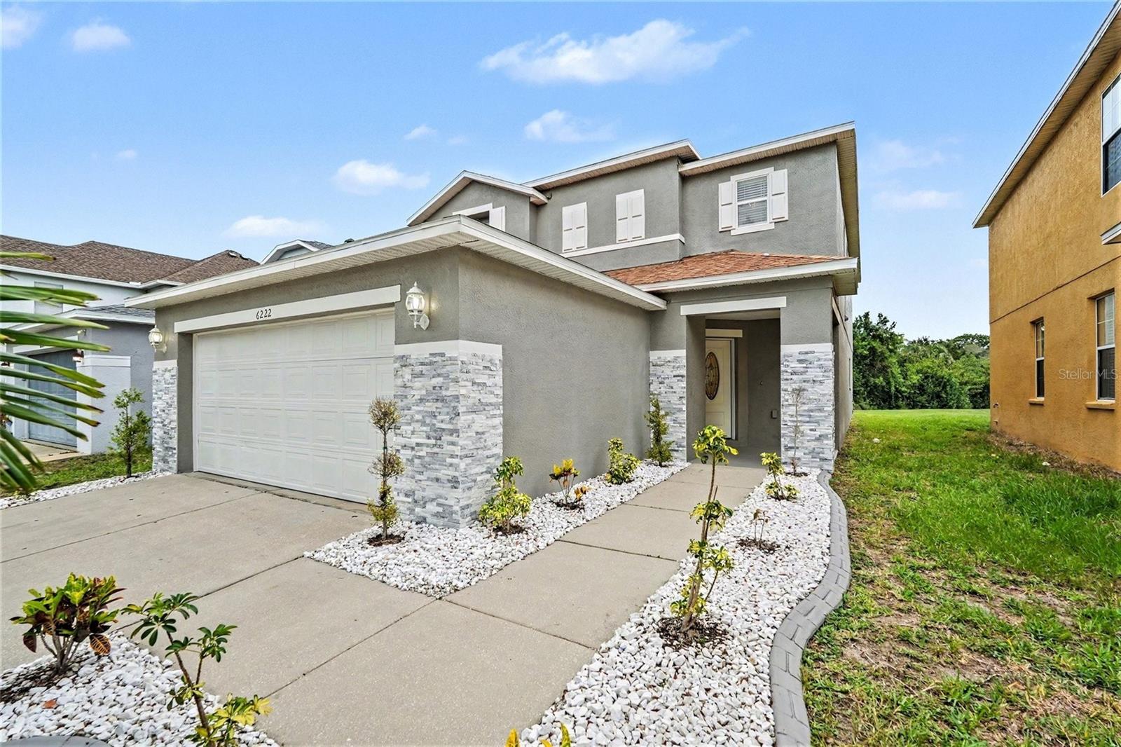Prepare to be impressed by this truly move-in-ready showpiece in the highly desirable Magnolia Trails community. Situated on a premium homesite overlooking a peaceful pond and wooded conservation area, this beautifully upgraded 4-bedroom, 2.5-bath home offers 2,496 square feet of stylish living space with no rear neighbors and exceptional privacy. From the moment you arrive, you'll appreciate the outstanding curb appeal, attractive stone accents, manicured landscaping, and pride of ownership that is evident throughout. Inside, the open-concept floor plan is designed for both comfortable everyday living and entertaining, featuring luxury vinyl plank flooring throughout, granite countertops, upgraded lighting fixtures, recessed lighting, and designer finishes in every room. The spacious kitchen serves as the heart of the home and showcases solid wood cabinetry with soft-close drawers, stainless steel appliances, granite countertops, a center island, and abundant storage. The kitchen opens seamlessly to the dining and living areas, creating an inviting space for gatherings large and small. The living room features a stunning custom stone accent wall with an electric fireplace, creating a dramatic focal point and adding warmth and character to the home. Upstairs, the spacious owner's suite offers a private retreat with room for a sitting area and beautiful views of the conservation area. The luxurious primary bathroom has been extensively upgraded and features a custom walk-in shower, designer vanity, granite countertops, and spa-inspired finishes. Three additional bedrooms, a full bathroom, and a conveniently located laundry room complete the second floor. Step outside and enjoy the tranquil setting overlooking the pond and wooded conservation area. Whether you're enjoying your morning coffee, relaxing after work, or watching local wildlife, the backyard provides a peaceful escape rarely found in this price range. Conveniently located just minutes from shopping, dining, entertainment, schools, and major commuter routes, this exceptional home offers the perfect combination of luxury, privacy, and convenience. The home shows like a model and is in exceptional condition. Select furnishings may be available for purchase separately, and the seller may consider including certain furnishings with an acceptable offer. This is a rare opportunity to own one of the most beautifully upgraded and meticulously maintained homes in the area. Schedule your private showing today.