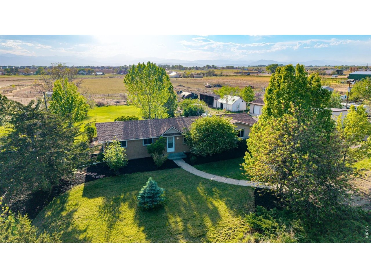 Buyer Bonus! $10,000 Seller paid interest rate buy down. RARE opportunity to own acreage close to Boulder with million-dollar views of the front range. Located in Weld County just 1/2 mile outside of Boulder County, easy commute to Boulder, Denver, or Fort Collins. No Metro Taxes No HOA. Freedom to live how you want on your 6.88 acres. The 3 bedroom, 1 and 3/4 bath ranch home with an oversized detached 4 car garage with workshop area, plus other outbuildings the 6.88 acres property. located on a paved, dead-end road, minutes to the grocery store or I-25. Inside, the updated home has hardwood floors, new carpet, newer windows, a double-sided gas fireplace, and updated kitchen and newly remodeled main bath. The home has central A/C and a high-efficiency boiler for heat. A bonus sun room on the back of the home is the perfect spot for entertaining, with a relaxing hot tub right outside. In the backyard, a large lily pond with a rock waterfall attracts wildlife including herons, ducks and other birds, and is surrounded by a landscaped garden area with stone walking paths and a cozy gazebo. The bushes and trees on the property are varied with several fruit varieties. The neighborhood is a small, quiet 'sub-division' called "Seemore Heights", NO HOA or covenants. Relax on the patio and enjoy the unobstructed views of much of the front range or gather with friends around the firepit. Use the corral, barn, and three stall loafing shed for your animals. Park your RV, boat and other toys right on your own property. Enjoy rural living with the lower cost-of-living of Weld County while still within easy access of all that Longmont and Boulder County in general have to offer. https://my.matterport.com/show/?m=YE61Z8KbmrZ