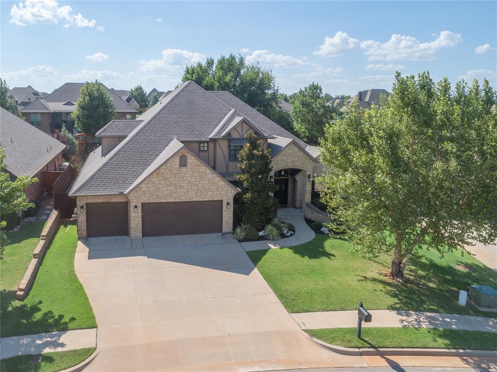 Welcome to this stunning and incredibly versatile 4-bedroom, 3-bathroom home with a study and bonus room, nestled in the highly sought-after Twin Bridges neighborhood, walking distance from Heritage Elementary. This residence offers an abundance of space for every need, complemented by a convenient 3-car garage. Upon entry, you are greeted by a grand staircase, a beautiful formal dining area, and a private study. The living room is truly the heart of the home, featuring a cathedral ceiling with a stained beam, a stacked stone fireplace, and oversized floor-to-ceiling windows that flood the space with natural light. The chef's kitchen boasts built-in appliances, quartz countertops, a large center island with bar seating, and a tucked-away wine/coffee bar, making it perfect for entertaining. The spacious primary suite is a private retreat with garden doors leading to the backyard, a tray ceiling with elegant trim detail, a luxurious en-suite bath with a large soaking tub and a walk-in tiled shower, and a massive walk-in closet with a center island. Upstairs, a versatile bonus room features a sliding barn door and a wet bar, ideal for hosting. The backyard is an entertainer's dream, with a large vaulted pergola covering the main patio and an extended patio area with a cozy wood-burning fireplace. This community offers amazing amenities, including ponds, walking trails, and a recreation facility with a pool, all just moments from everything Edmond has to offer. Don't miss the chance to make this exceptional property yours—schedule your showing today!