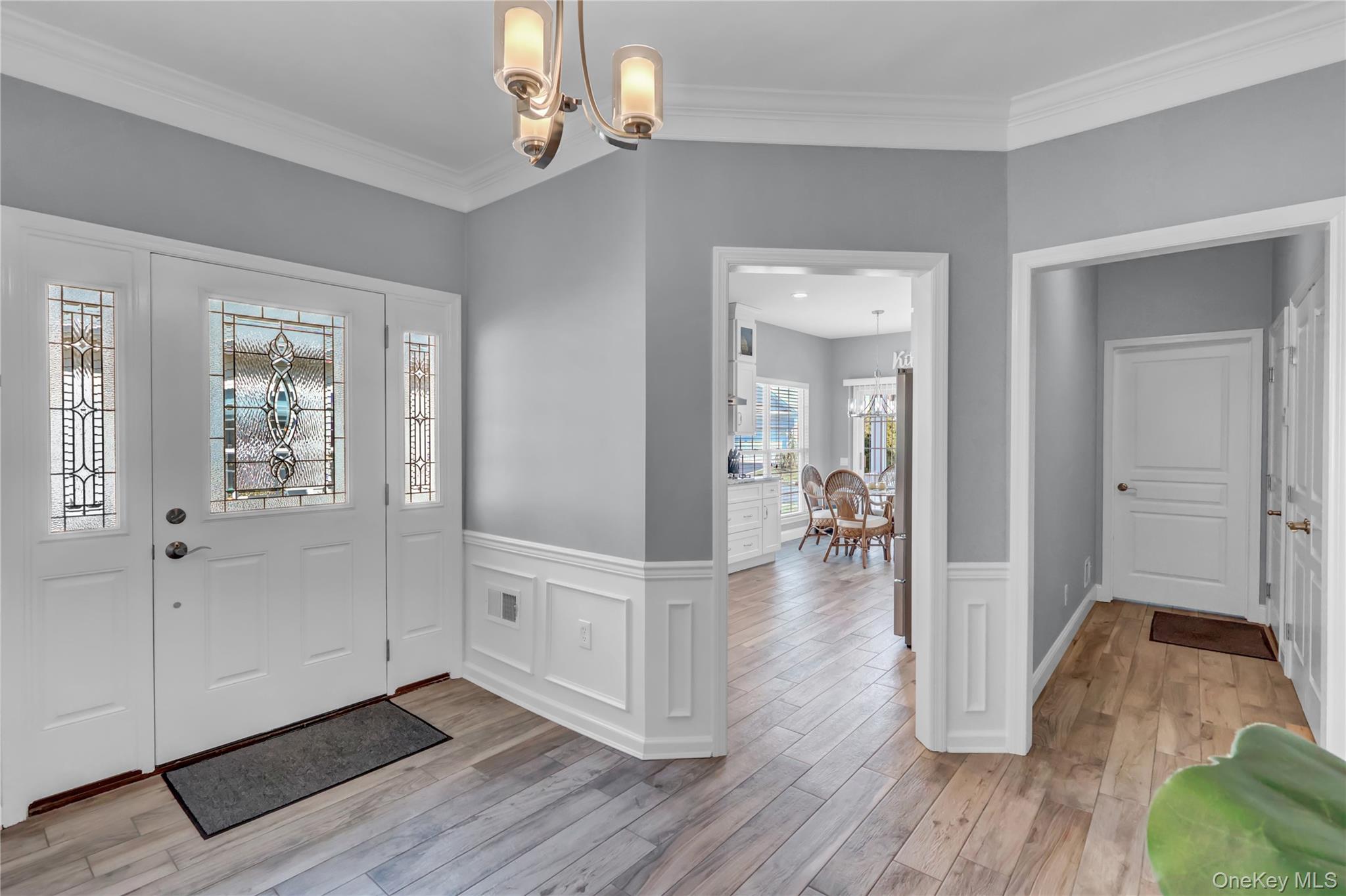 Luxury is all about Lifestyle! This magnificent, totally renovated home is the perfect retreat for everyday living! Details exceed perfection! Nothing has been compromised in this approximately 2500-square-foot Astor model Home. Elegance, exceptional design, and architectural details, with custom craftsmanship and Crown Molding throughout. This sophisticated, Open floor plan seamlessly blends throughout this home. Upon entering, you are welcomed by vaulted ceilings in the den with a fireplace, open to a beautiful Sunroom with sliding doors that lead to the brick patio. The open floor plan adjoins a Banquet-size Formal Dining room, and at the heart of this home is the Gourmet Kitchen, featuring Custom Cabinetry, top-of-the-line appliances with double oven, Quartz countertops, a farmhouse sink, and a large breakfast dining area with sliding doors that lead to the covered porch. The first floor offers a Master Suite with large bay windows, walk-in closets, and an ensuite Master bathroom. Additional bedroom/Den and full bath.Second level is an Expansive Loft/Family room perfect for entertaining or relaxation, an additional Bedroom, and a full bath. Additional features include porcelain-planking flooring throughout the first floor, a new garage door, a new one-zone main compressor, a new water heater, new blinds, a laundry room, and a 2-car garage.This home is located in a much sought-after community, The Villages at Mt Sinai Park, a double security gated 55+ Community with amenities that include a Clubhouse (social room, kitchen, card room, full gym, Indoor pool), Outdoor heated pool, 2 tennis courts, Pickleball, 2 Bocce courts, and putting green. This property is conveniently located close to Heritage Park, beaches, restaurants, shopping, and close to the Port Jefferson train station. A must- see to truly appreciate all the details that make this home!!!