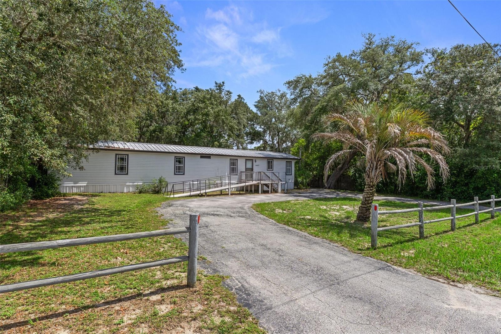 Nestled on a beautiful half-acre consisting of two lots, this well-maintained 2-bedroom, 2-bath home offers space, privacy, and convenience. The unique property extends from one street to the next, providing excellent access and endless possibilities. A detached 2-car garage with electricity is great for vehicles, a workshop, storage, or hobby space. The fully fenced yard offers plenty of room for pets, gardening, and outdoor activities, while the circular driveway provides easy access and ample parking for guests. Enjoy the charm of country-style living with the convenience of a spacious lot and versatile outdoor amenities. Don't miss this opportunity to own a property with room to spread out and make it your own!
