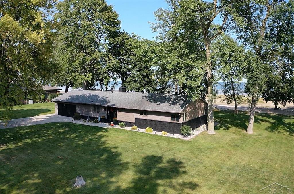 Experience the ultimate waterfront lifestyle on North Linwood Beach. This beautifully renovated 4 bedroom, 2.5 bath home sits on 2 acres with 200 feet of private Lake Huron frontage, offering breathtaking sunrises over Saginaw Bay. Unlike most homes on the beach, this property provides exceptional privacy with plenty of room between neighbors. Inside you'll find modern finishes throughout, including a showpiece kitchen with oversized island, granite countertops, custom cabinetry, and premium appliances. The primary suite is a private retreat, while the spacious living and dining areas with dual fireplaces are perfect for gatherings. A finished heated, cooled, and screened garage adds versatile year-round living space.  Step outside to enjoy a custom patio, new hot tub, and endless ways to soak in the shoreline. A circle drive, heated workshop, and insulated pole barn with loft and storage across the street add convenience. Located in the small lakeside town of Linwood, this property is just a short ride to Linwood Beach Marina for world-class boating and fishing. Enjoy the sunrise side lifestyle where modern comfort meets the peace and character of a quiet waterfront community.