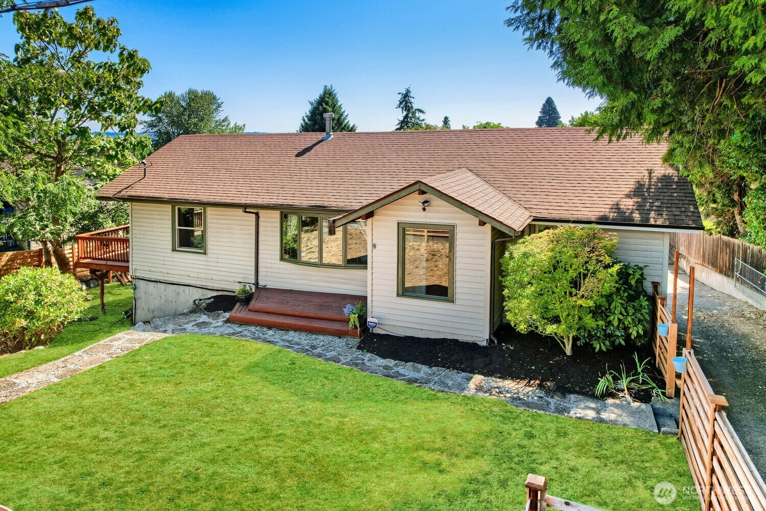 Rare Renton opportunity offering space, flexibility, and a true in-city homestead feel! This home sits on a spacious 0.47-acre lot and features beautiful Mt. Rainier views, multiple outdoor decks, fruit trees, a vegetable garden, and a chicken coop. The main level offers a comfortable kitchen, living and dining spaces, two bedrooms, and a full bath, while the finished daylight basement provides an additional kitchen space, more bedrooms, a full bath, laundry, and a large family room. The flexible layout is ideal for multi-generational living, extended guests, or those looking to live in one portion of the home while renting another. Outside, enjoy RV parking with hookups, a large detached garage/shop, off-street parking for up to 6 cars, and plenty of room for gardening, entertaining, hobbies, pets, and recreational toys. Additional features include ductless heating and A/C, hardwood and tile flooring, and a newer sewer liner. Conveniently located near shopping, dining, parks, schools, and major commuter routes, this property offers the rare combination of generous land, versatile living space, outdoor amenities, and easy city access.