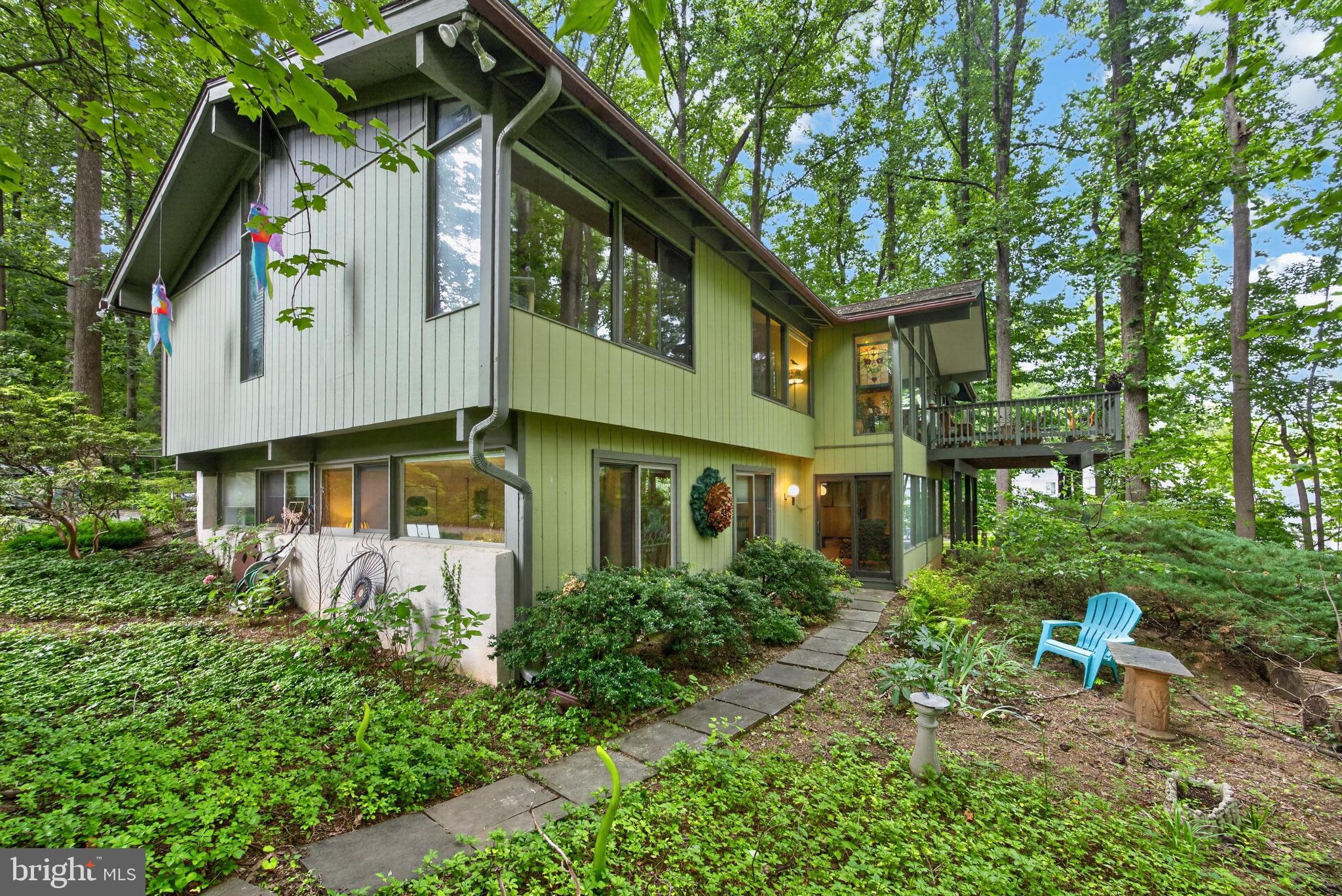 Welcome to a rare opportunity to own an architecturally significant Robert McElroy-designed contemporary residence, privately nestled on a beautifully wooded .58-acre lot in desirable Berwyn and the award-winning Tredyffrin-Easttown School District. Thoughtfully positioned to embrace its natural surroundings, this exceptional home showcases the timeless design principles that have made McElroy one of the Philadelphia region's most celebrated architects—soaring vaulted ceilings, exposed beams, expansive walls of glass, skylights, and a seamless connection between indoor and outdoor living.A welcoming covered courtyard entry, complete with a tranquil koi pond, offers a peaceful introduction to the home and sets the tone for the serenity found throughout. Freshly painted inside and out, the residence has been meticulously maintained while thoughtfully updated to preserve its architectural integrity.Inside, more than 3,400 square feet of light-filled living space unfolds with rich hardwood floors flowing throughout the main living areas. Walls of windows frame picturesque woodland views from nearly every room, creating an ever-changing backdrop that brings nature indoors year-round.At the heart of the home is the beautifully updated kitchen featuring abundant custom cabinetry, granite countertops, a center island with seating, stainless steel appliances, skylights, and expansive windows overlooking the surrounding trees. The kitchen flows seamlessly into the sun-filled breakfast room, where one side of the striking two-sided wood-burning fireplace creates a warm and inviting atmosphere. The adjoining Great Room showcases soaring vaulted ceilings, walls of glass, and the opposite side of the fireplace, making it an exceptional space for entertaining or relaxing. Step directly onto the spacious deck to enjoy morning coffee, outdoor dining, or simply unwind while immersed in the peaceful wooded setting.The spacious primary suite is a true retreat, highlighted by a stunning spa-inspired ensuite bath featuring a freestanding soaking tub, oversized walk-in shower, dual floating vanity, designer finishes, skylights, and walls of glass that create a calming connection to nature. A beautifully remodeled hall bath offers equally stylish finishes and serves the additional bedrooms.The flexible floor plan includes a total of four generously sized bedrooms, three full bathrooms, multiple living and entertaining spaces surrounded by windows and woodland views, and an expansive lower-level family room with slider to the exterior.Outside, mature trees, thoughtfully landscaped grounds, and multiple outdoor living spaces provide exceptional privacy and a true sense of retreat while remaining just minutes from the Main Line, Berwyn, Paoli, regional rail, shopping, dining, and major commuter routes.Completing the home is an oversized two-car garage with a walk-up loft offering abundant storage rarely found in homes of this architectural style.Robert McElroy homes are treasured for their enduring design, harmonious relationship with nature, and timeless architecture. Beautifully updated while remaining true to its original vision, this exceptional residence offers a rare opportunity to own a piece of Main Line architectural history.