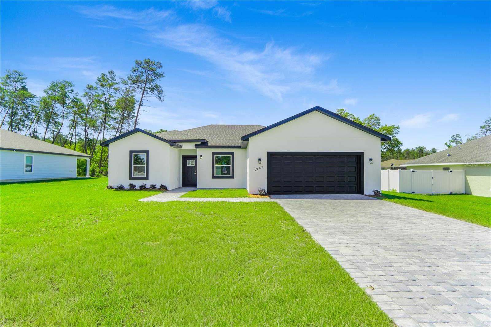 One or more photo(s) has been virtually staged. Beautiful New Construction Home in Ocala | Unique & Highly Desired Floorplan in Prime LocationDiscover this stunning new construction home in Ocala, featuring a unique and highly desired floorplan designed to deliver both comfort and modern style from the moment you walk in. Thoughtfully laid out to maximize space and functionality, this home offers 4 spacious bedrooms, including a standout primary suite with a generous walk-in closet. The additional bedrooms feature built-in closets, providing practical and organized living for the whole family.With 3 full bathrooms finished using quality materials, every detail complements the home’s contemporary design. Step into a bright and airy open-concept layout where the expansive living room flows seamlessly into the dining area—perfect for entertaining guests or enjoying everyday living.The kitchen serves as the heart of the home, showcasing solid wood cabinetry, elegant stone countertops, and included appliances, making it move-in ready from day one.Enjoy peaceful moments on the welcoming front porch, ideal for morning coffee or relaxing evenings. The stylish paver driveway enhances curb appeal, while the 2-car attached garage offers both convenience and additional storage space.Perfectly located near a main road for easy access and close to highly rated schools, this property combines tranquility with accessibility. Whether you're searching for your dream home or a smart investment opportunity, this residence offers exceptional value in one of Ocala’s most desirable areas.