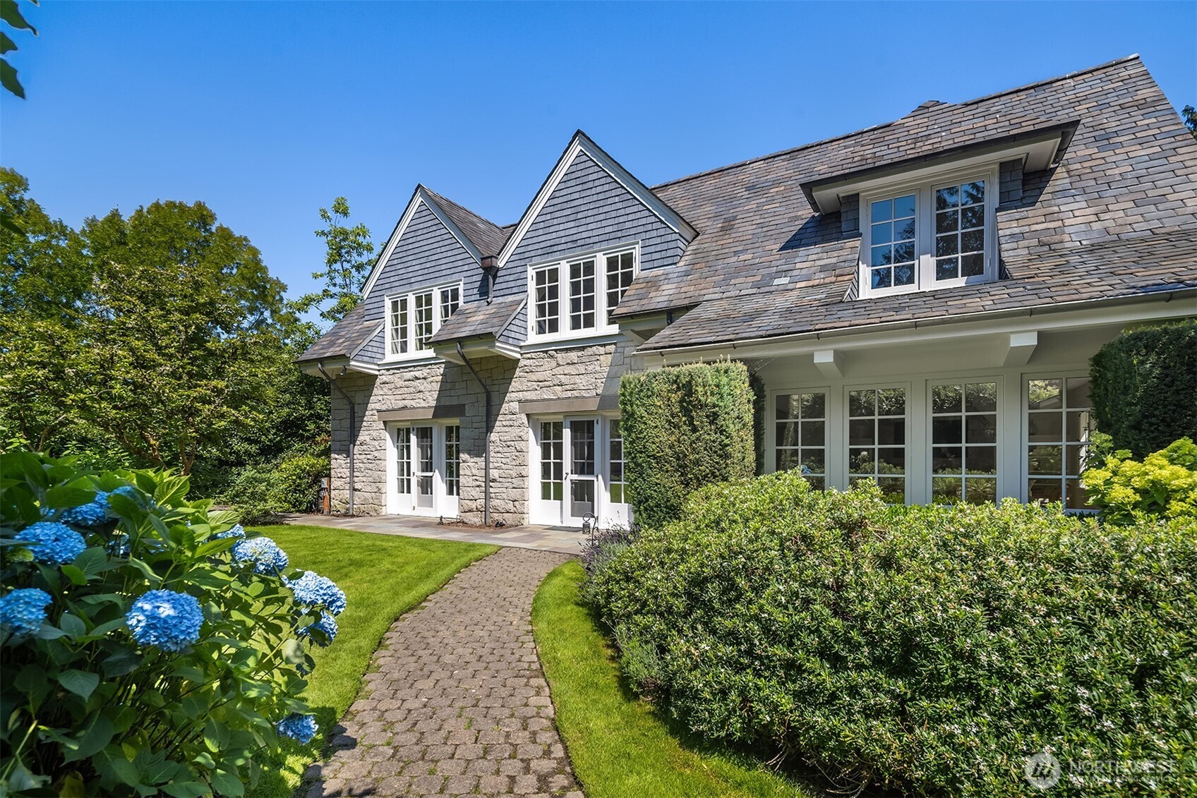 Charming curb appeal with a welcoming paved drive.