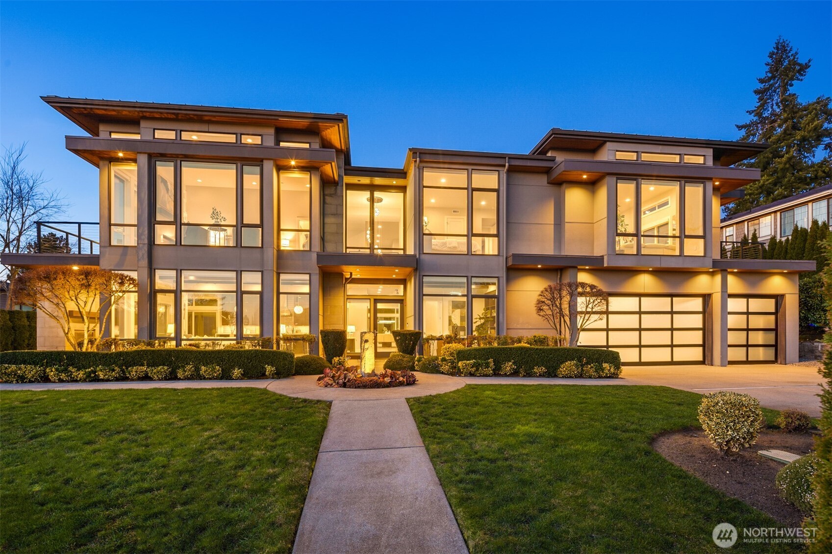 Stunning Contemporary MN Custom Homes Resale located on a private road in the heart of Clyde Hill. This exceptional property combines luxury, comfort, and sustainability with impressive Green Home and Smart Home features — including solar panels, a durable metal roof, electric car charger, and Alexa-enabled garage doors, lighting, and power systems. The main floor offers a spacious guest suite, home offices, and a versatile bonus room perfect for a tearoom or gym. The gourmet kitchen features Sub-Zero/Wolf appliances, an eat-in area, and opens to two heated outdoor living spaces. Every bedroom includes its own en-suite bathroom. Upstairs the primary suite is a true retreat with a cozy fireplace, private deck, expansive walk-in closet, and a luxurious spa-inspired bath. A separate laundry setup adds convenience. Additional amenities include a professional home theater, recreation and playrooms, and an upper-level deck with mountain and Lake Washington views. Situated within the nationally ranked Bellevue School District, this home offers the perfect blend of innovation, elegance, and functionality — better than new.