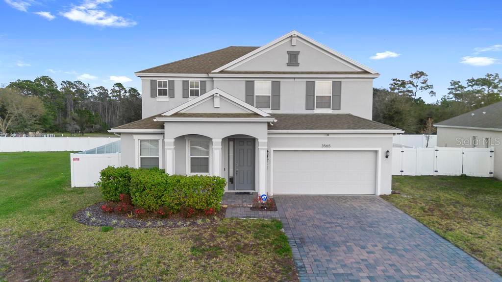 Step into this spacious and thoughtfully designed two-story home, where comfort, privacy, and modern elegance come together. Boasting five bedrooms and three and a half bathrooms, this home is perfect for multi-generational living or anyone seeking extra space and storage. As you enter, you're greeted by large foyer with an open and inviting great room, seamlessly connected to a chef’s dream kitchen featuring gleaming granite countertops, a large center island, a double oven, an oversized double sink and a walk-in pantry big enough to fit all your essentials and more. The split-bedroom layout on the first floor offers both convenience and privacy, with two bedrooms and two  bathrooms, making it ideal for guests or extended family. Upstairs, a spacious loft acts as a perfect separation between the primary suite, which boasts an ensuite bathroom and a generously sized walk-in closet. The two additional bedrooms are connected by a Jack-and-Jill bathroom with separate entrances. Every bedroom features ample closet space, ensuring there’s room for everything. What truly sets this home apart is the exceptional privacy—situated on an easement with no direct side neighbor and no neighbors behind, you’ll enjoy a sense of peace and seclusion rare to find. A pristine vinyl fence wraps around the backyard, adding even more privacy to your outdoor space. Located in a beautiful community with a large pool and pavilion for residents and low HOA fee, this home is perfect for enjoying Florida’s year-round sunshine. Thoughtfully placed with quick access to State Road 415 and Howland Blvd, you're just minutes from major highways, hospitals, shopping, restaurants, beaches, coffee shops, markets, and top-rated schools. This almost-new home offers the perfect blend of space, style and location—don’t miss the chance to make it yours!