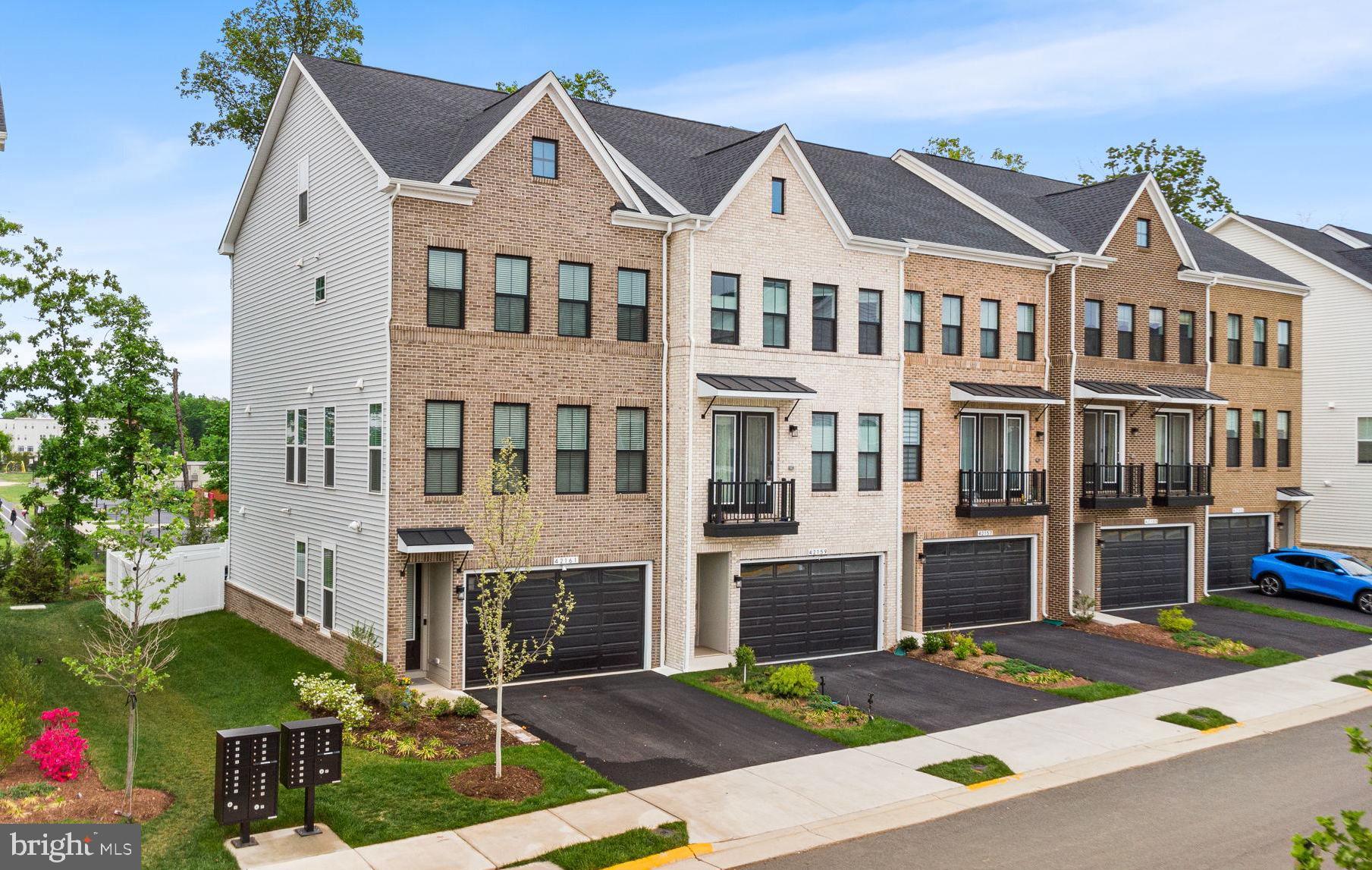 Welcome to this stunning, newly built ALTO floorplan by Van Metre Homes, located in the highly sought-after West Park community of Brambleton. Offering over 3,000 finished square feet across four thoughtfully designed levels, this exceptional townhome features 4 bedrooms, 4 full and 1 half bathrooms, a 2-car front-load garage, private deck, rear yard, and a rare loft level with a rooftop terrace.The main level showcases a rear, heart-of-the-home gourmet kitchen complete with upgraded cabinetry, quartz countertops, an extended backsplash, farmhouse sink, stainless steel appliances, gas cooktop, under-cabinet lighting, and a large center island. Premium built-in Sonos media speakers make it perfect for entertaining. The open-concept layout flows seamlessly into the dining and living areas, enhanced by wide luxury vinyl plank flooring and abundant natural light from the premium end-unit location, along with direct access to the spacious deck.The upper level features an impressive primary suite with a walk-in closet and a spa-inspired bathroom, including double vanities and an oversized frameless glass shower with built-in seating. Two additional bedrooms, a full bath, and a conveniently located laundry room complete this level.The fourth-floor loft offers a versatile bonus space with a full bathroom and access to a private rooftop terrace, ideal for relaxing or entertaining. The ground level includes a multi-generational bedroom suite with a full bath and walkout access to the fenced, tree-lined backyard, enhanced by a stone patio and sprinkler system.This home is fully upgraded with over $200K in builder enhancements, including luxury vinyl plank flooring throughout, oak stairs on all levels, modern iron railings, designer lighting, a finished garage with epoxy flooring, a tankless water heater, a smart thermostat, integrated networking and audio/video wiring throughout, and outdoor connectivity for future surveillance.West Park is ideally located directly across from Hal and Berni Hanson Regional Park and offers easy access to Brambleton’s award-winning amenities, including pools, clubhouses, fitness centers, tennis courts, playgrounds, and miles of scenic trails. Just minutes away, Brambleton Town Center provides shopping, dining, groceries, and community events, while One Loudoun offers upscale restaurants and nightlife. Commuters will appreciate proximity to the Washington Metro Silver Line at Ashburn Station, Washington Dulles International Airport, and major routes including the Dulles Greenway and Toll Road.This is a rare opportunity to own a nearly new, fully upgraded, turn-key home without the wait for new construction, offering exceptional value, modern luxury, and an unbeatable location.