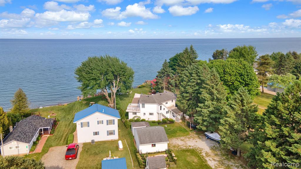 75 feet of sparkling Lake Huron frontage awaits!
Wake up to the sound of gentle waves and panoramic water views in this beautifully updated 5-bedroom, 2.5-bath home. Nearly every room captures the breathtaking scenery, making it easy to relax and reconnect with nature.

Inside, you’ll find a brand-new kitchen with upscale appliances, new main-level flooring, and refreshed bathrooms. The spacious Great Room with a natural fireplace is perfect for cozy evenings, while the wraparound sunroom invites you to enjoy morning coffee or stargaze at night—year-round lake living at its best.

Three main-floor bedrooms and two full baths provide easy convenience, with two more bedrooms and a half bath upstairs for family and guests.

The outdoor space is a true retreat: multiple firepits, a small decorative pond, a sauna, and several sheds surround the 2.5-car garage with attached work/office room. A gentle slope leads to your own sandy “upper beach,” where an updated steel seawall and newly installed stairs give effortless access to the water.

Whether you’re dreaming of a private getaway or a ready-to-go short-term rental, this property delivers both.

This isn’t just a house—it’s the Lake Huron lifestyle. Come see it and start making memories on the shore.