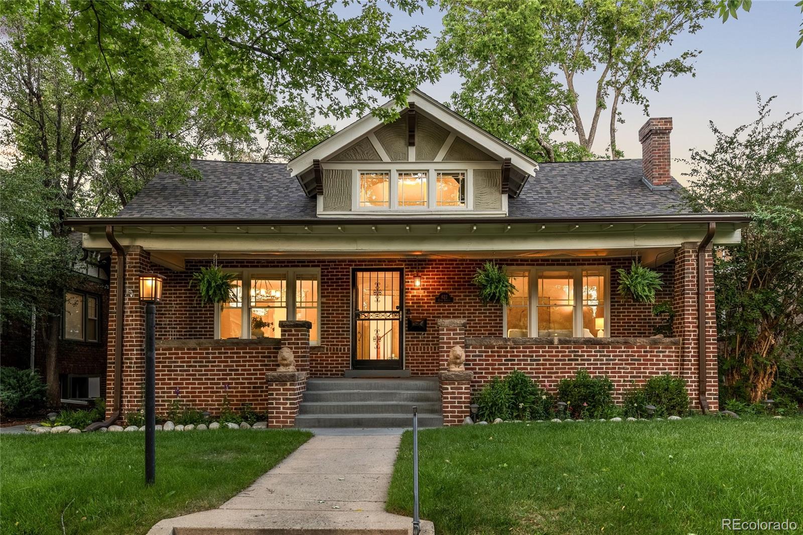 Your search for a lush, 2-story oasis in the heart of Congress Park ends here. Steeped in an enviable locale 1 block from Cherry Creek on a quiet street, this residence is defined by its open floorplan, historic charm & timeless updates. Stunning curb appeal invites guests onto the sprawling, covered front porch. Original molding, hardwood floors, built-ins, a statement fireplace & a row of windows are some of the small details that make this house an enchanting home. Entertain in the sunlight-drenched & recently updated kitchen that showcases shaker cabinets, quartz countertops, a gas range, seating for 4+ and ample storage. The adjacent living space is beaming with natural light and easy patio access while the formal dining space is a treat with original features throughout and is perfect for large gatherings. The main floor primary suite beckons peaceful rejuvenation with a separate office/seating area and a spa-like bath w/ a dual vanity, a soaking tub, an oversized shower and a walk-in closet. Indoor/outdoor connectivity is paramount and the kitchen + living room connects directly to the backyard via large patio doors. The green space is an entertainer’s & gardener’s dream with a large seating area, a pergola, bistro lighting and professional landscaping. Back inside the home, the second level features a flex living space and with vaulted ceilings, 2 bedrooms and a newly renovated full bath. A sublime lower level amplifies the entertainment capabilities of this home with a large flex space, another bedroom and multiple storage areas. Revel in the convenience of an oversized two-car garage, automatic irrigation + drip system, mature trees and a new roof. This opportunity will not last long.