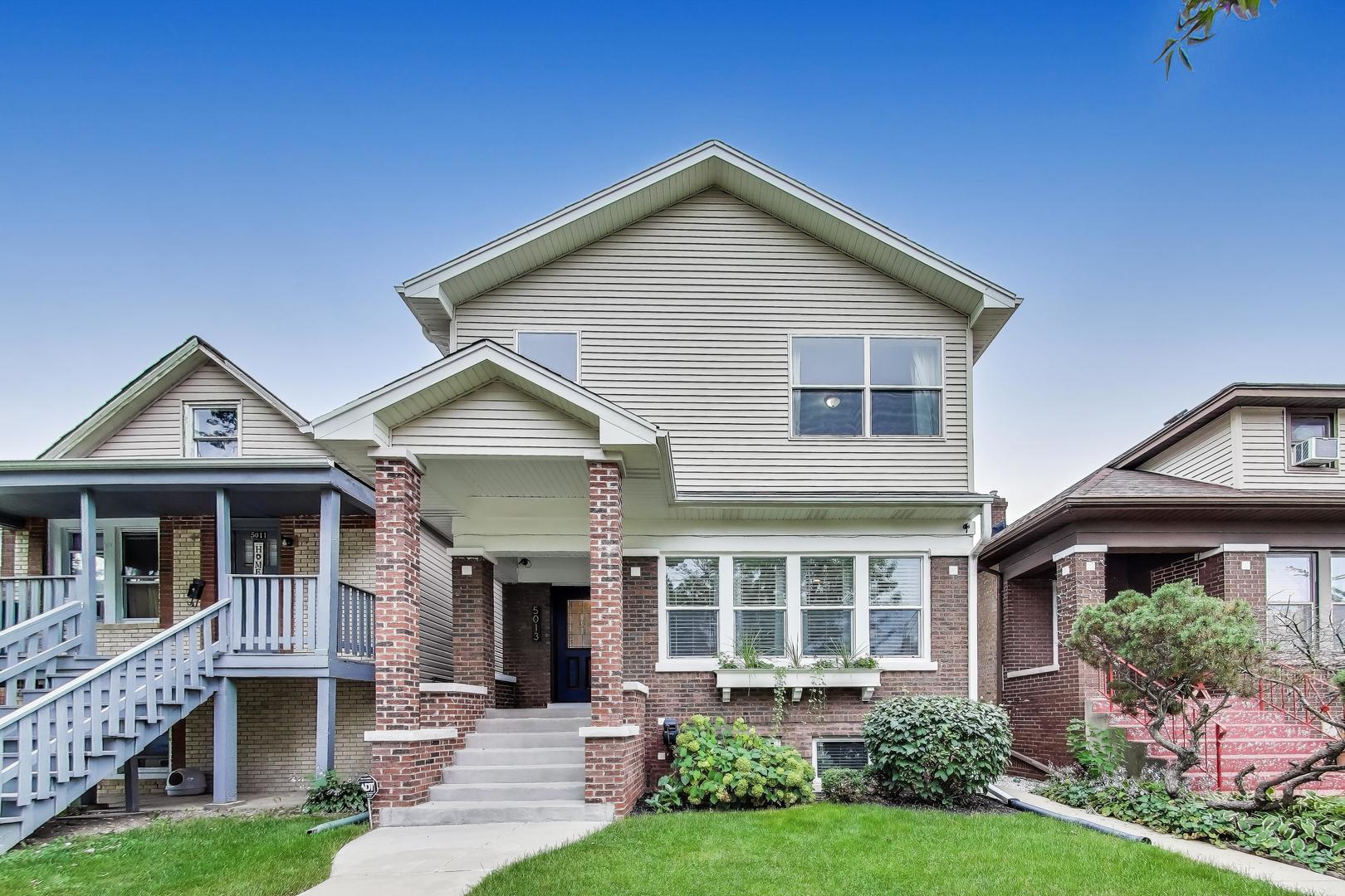 Welcome to this beautifully reimagined contemporary Chicago home in the heart of Portage Park. Originally a classic bungalow, this residence has been graciously expanded with a full second story addition and a finished lower level. A perfect layout for modern city living with 5 bedrooms, an additional versatile room for an office or creative space, and 3.5 baths.    Step past the brick pillars at the front door and enjoy an open floor plan with hardwood floors and draped custom window treatments. Moving through the main floor, you are greeted by the newly renovated kitchen featuring opulent lighting fixtures, sleek cabinetry, granite countertops and premium stainless steel appliances. A space ideal for everyday meals and entertaining guests. Upstairs, take in the primary suite with architectural built-ins leading to ample walk-in closet space and a double vanity en-suite bath.    Enjoy alfresco dining on the attached deck, fully designed with locally crafted wooden benches that blend style and functionality. Tailored privacy screens create a secluded atmosphere. This outdoor haven invites long conversations, morning coffees, and weekend BBQs. From there, walk into the fully fenced yard leading to a 2-car detached garage, complemented by an additional carport for a third vehicle or flexible use.     Homeowners have meticulously maintained every corner of this home. A true gem located just steps away from Portage Park, Target, Jewel, Aldi, cafes, restaurants, and boutique shops. Also conveniently located near public transportation and the Kennedy expressway.