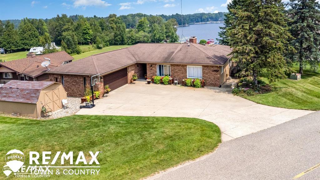 Room for everyone at Lake Lancer in Sugar Springs. Welcome home with over 4,000 sq ft of beautifully designed living space, on .60 acres with 70 ft of frontage on Lake Lancer in the heart of Sugar Springs. This stunning 4 bedroom 3 full bath home delivers space, comfort, and panoramic water views from nearly every main living area. Whether you're starting your day with a coffee or hosting a weekend getaway, the scenery never disappoints. This home has so much to offer. Come relax in your living room, family room, sunroom, 2 kitchens, a separate dining room/office/bonus, large bedrooms and so much more. Buy today and enjoy all the seasons with your family making memories on the water. Located in the sought after Sugar Springs community, you'll have access to top tier amenities: a clubhouse, 18 hole golf course, pool, restaurant, private beaches, fitness center and so much more. https://sugarsprings.net/ Whether you're searching for a full time residence or the ultimate getaway this Lake Lancer gem checks every box. Schedule your showing today