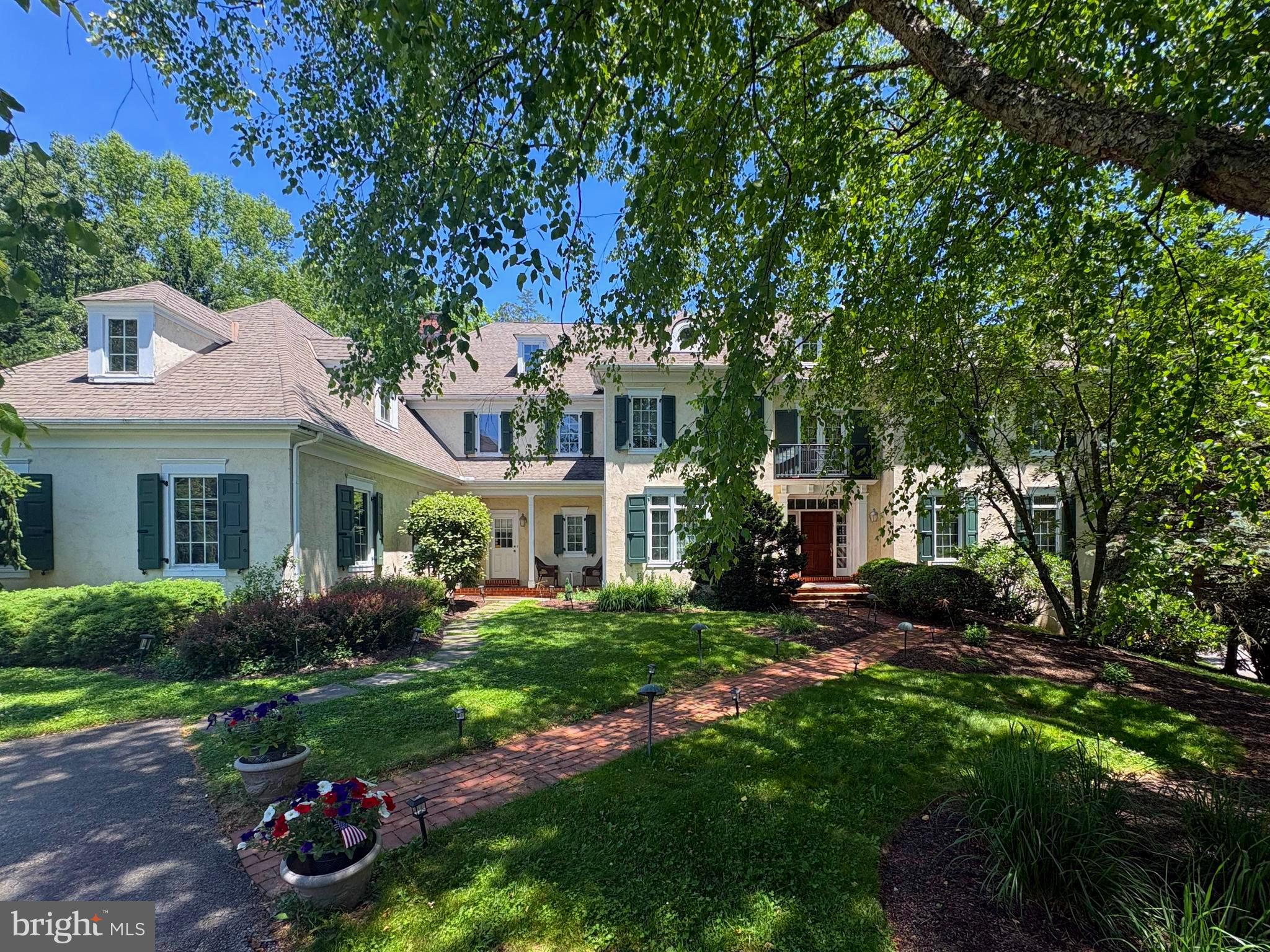 Motivated Seller! Nestled on a beautifully landscaped 0.79-acre lot in the sought-after Harriton Farm neighborhood of Villanova, this elegant center hall Colonial offers 5 bedrooms, 4 full bathrooms, and 2 half bathrooms with exceptional indoor and outdoor living spaces. A heated in-ground pebble pool with jacuzzi/hot tub and expansive flagstone patio create a private backyard retreat perfect for relaxing or entertaining while enjoying the serene surroundings. A grand entry with open staircase and large windows welcomes you into the home, where beautiful hardwood floors and exquisite architectural detailing flow throughout the first floor. The formal living room with crown molding and wood-burning fireplace opens seamlessly to a richly appointed office/den with dark wood finishes.  The formal dining room with crown molding provides the ideal setting for hosting dinner parties both grand and intimate.  A charming Country Craft bar and service area connects the dining room to the spacious chef’s kitchen featuring Country Craft Cabinets, a large center island with gas cooktop, double wall ovens, stainless steel appliances, built-in desk area, and a sunny breakfast room overlooking the picturesque backyard. The kitchen flows effortlessly into the bright and inviting family room with a wood-burning fireplace, abundant natural light, and tranquil backyard views. Two convenient half bathrooms complete the main level, including one located off the mudroom with access to the impressive, built-in 4-car garage. The second floor features a luxurious primary bedroom suite with a fireplace, a separate sitting room, two walk-in closets, and a spacious en-suite bathroom with a soaking tub. A second bedroom offers private access to a full hall bathroom, while two additional bedrooms share a Jack and Jill bathroom. Convenient second-floor laundry.  Expansive flex space offering endless possibilities for a media room, fitness studio, playroom, or executive office completes this level. The finished lower level provides incredible versatility with a large recreation/playroom, additional bedroom, full bath, and outside entrance, making it ideal for an au pair suite, guest quarters, or extended family living. Located in the award-winning Lower Merion School District on a quiet cul-de-sac and just minutes from major roadways, shopping, dining, and Center City Philadelphia, this exceptional home combines timeless elegance with modern comfort in one of the Main Line’s most desirable neighborhoods. Interior photos have been virtually staged.