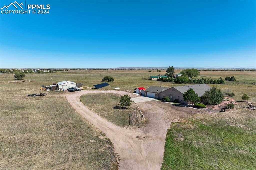 Come Experience an Oasis/Playground in the Country on this Fantastic One-Level Ranch Home on 11.52 Acres in Great Location * 1 Block Off Hwy 24 * Beautiful Lot with Pond, Trees & Fenced with Great Views * 50 x 30 Shop/Garage/Barn *Greenhouse * Granite Tile Counters * Large Master Retreat with Sitting Room/Study Walking Out to 25 x 13 Sunroom *Spacious & Cozy Living Room & Family Room * Knotty Pine Ceilings & Tile & Laminate Wood Floors Throughout & Large Extra Bedrooms & Office * Gorgeous Santa Fe Style Courtyard with Seasonal Flowers * Separate Playground for All the Kids
* No Covenants * A-35 Zoning * A Must Must See!!!