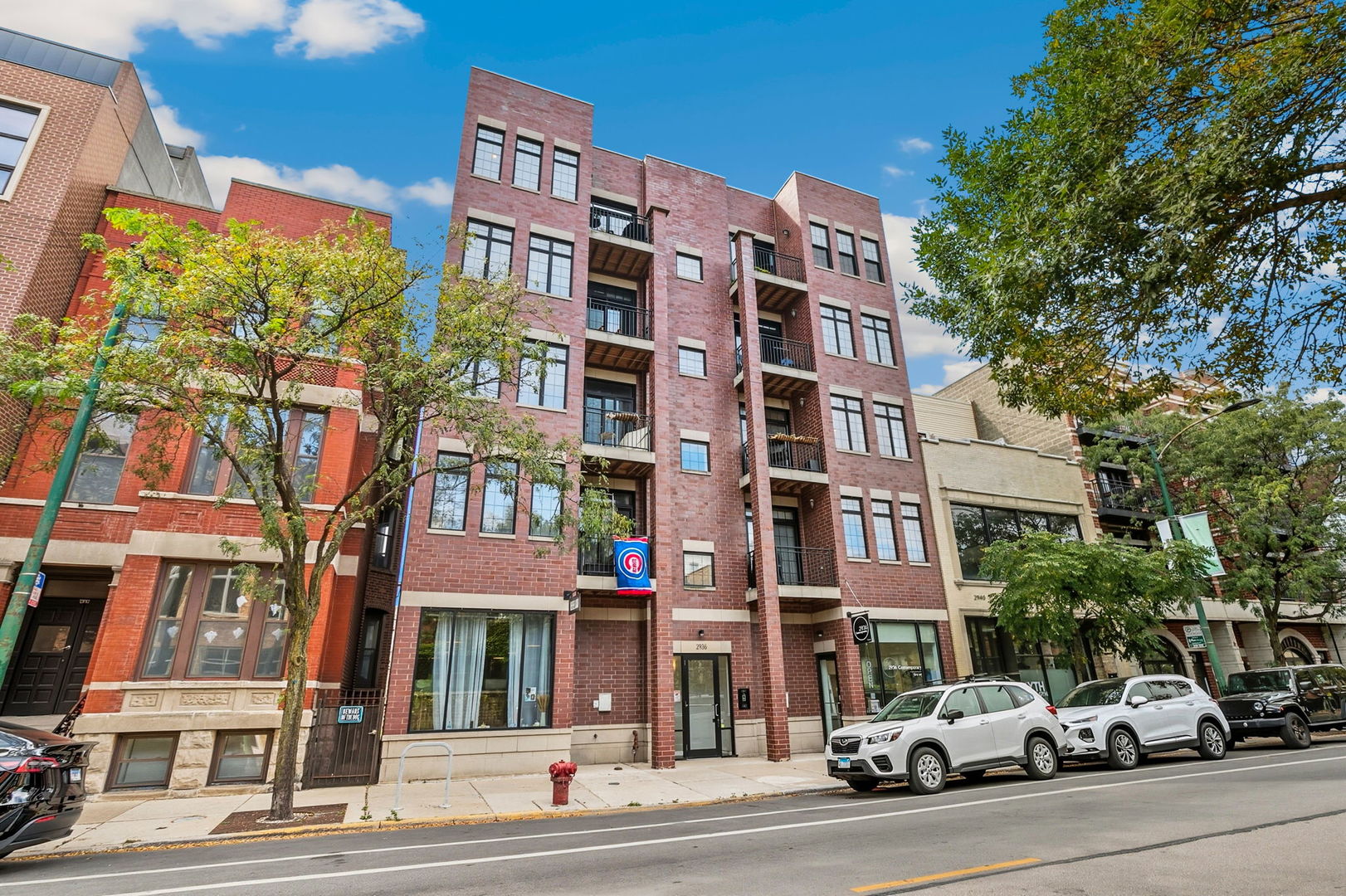 Welcome home to this spacious and beautifully updated 2-bedroom, 2-bath condo in an intimate 8-unit elevator building in prime Lake View location with only two units per floor. This extra-wide unit offers an open-concept kitchen, living, and dining area that lives larger than your average unit and features an accented electric fireplace. The living and dining areas provide plenty of room to entertain or relax, while the updated eat-in kitchen features two tone white and brown cabinetry with modern hardware, subway tile backsplash, white quartz countertops with a waterfall island, and updated appliances. Expansive front windows flood the space with natural light and open to a private balcony through sliding glass doors, with an adjacent nook that's perfect for a home office or reading area. Down the hallway toward the bedrooms, you'll find a spacious laundry room with side-by-side full-size washer and dryer, plus an ELFA storage system above. Across the hall is a generous coat closet, also outfitted with ELFA organization. The secondary bedroom features hardwood floors, dual closets, and is next to large secondary bathroom with walk-in shower and glass door. The primary suite impresses with gorgeous custom accent wall, updated wall sconces, and a massive walk-in closet with custom ELFA system. The spa-like ensuite bath has been updated with new black fixtures, and features massive tub and walk-in shower. Perfectly situated within the sought-after Burley School District, this home offers easy access to Lincoln Avenue's best restaurants, shopping, bars, and boutiques. Garage parking is included in the price.