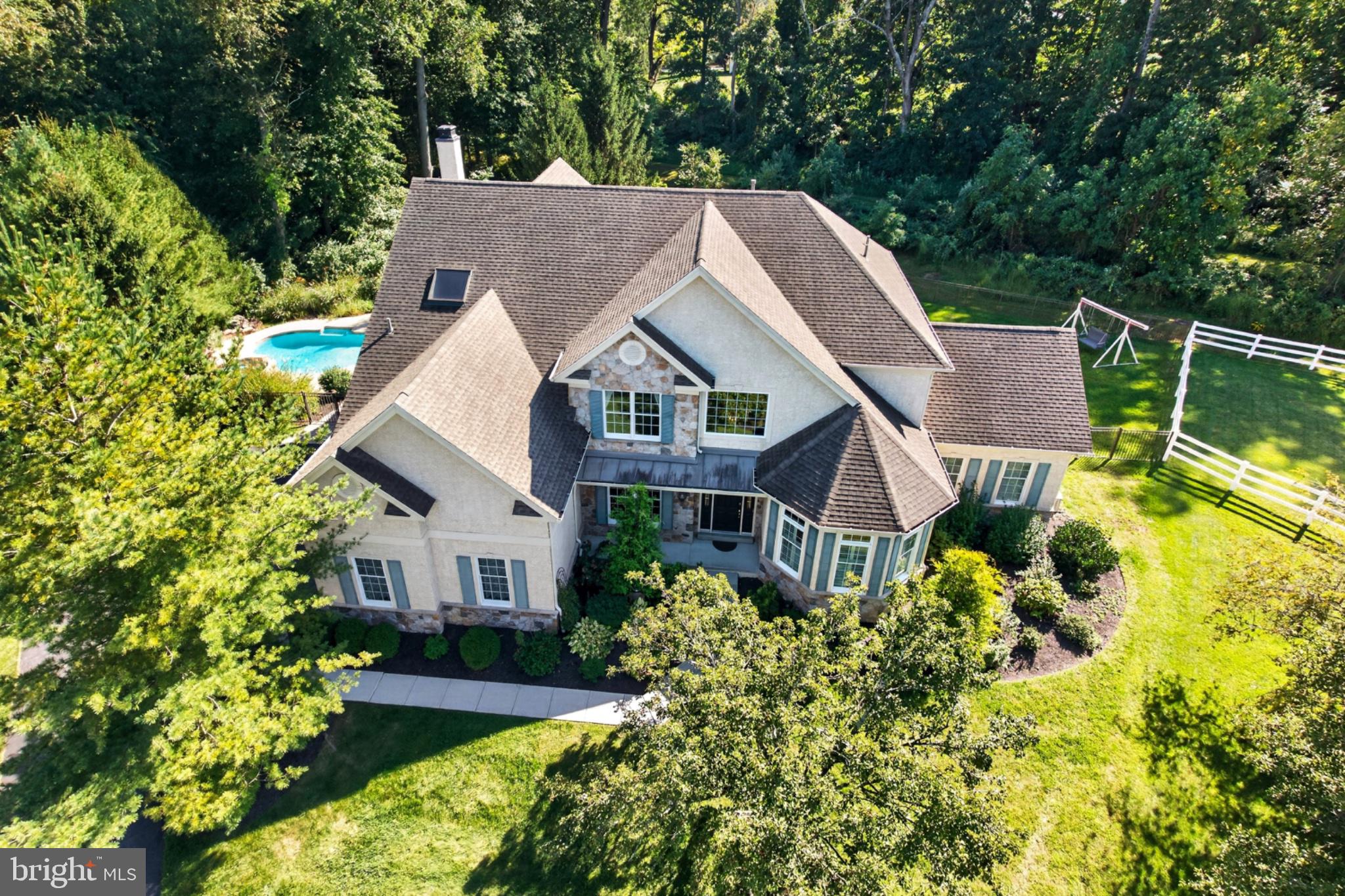 We cordially invite you to take a closer look at this stately Belmont floor plan tucked away on a quiet cul de sac in the highly desirable community of the Reserve at Eagle located in Chester Springs within the Downingtown East schools and Stem Academy. The thoughtfully  designed floor plan with its open and inviting layout offers a seamless flow from room to room creating an ideal setting for effortless entertaining. The formal two story entry foyer is complimented by a graceful sweeping curved staircase and hardwood floors through out, in the living room and sunlit conservatory, powder room with pedestal sink  and study which is accessed through glass paneled French doors allowing natural light to flow through creating an inviting sense of openness while maintaining a refined separation from the main living spaces. The gracious  formal dining room is enhanced with a tray  ceiling creating an inviting setting for memorable gatherings.  An inviting sunroom offers a welcoming connection to the outdoors through its soaring vaulted ceiling, skylights, distinctive windows and complemented by elegant stone tile flooring. A two story great room with floor to ceiling stone gas fireplace, back stairs and an expansive wall of windows frames a picturesque poolside setting surrounded by a backdrop of trees and greenery creating a serene and secluded ambiance.A well appointed kitchen with a breakfast area features 42” raised panel cabinetry, granite countertops, elegant stone tile flooring, a generous center island and there is a  double oven adding both convenience and functionality. The second floor bedrooms are appointed with hardwood flooring adding warmth, character and timeless appeal. Two generously sized bedrooms share a convenient Jack-and-Jill full bath.  The princess suite  offers a welcoming retreat complete with its own full bath providing comfort and convenience for family members or guests. French doors  lead to the gracious primary suite with sitting room area, large walk in closet and bath with double vanity,  commode area, whirlpool tub and stall shower creating  a comfortable and tranquil retreat. The sunroom, princess suite, study and Jack-and-Jill bath have been recently repainted.The expansive 1,900 sq.foot finished basement offers exceptional versatility, with ample space for recreation, full bathroom,  plus 2 bedrooms and a convenient laundry area. The generous finished space provides numerous possibilities for living, entertaining, and hobbies.. An expansive maintenance free deck provides plenty of room for entertaining, while the adjoining patio leads directly to the finished lower level and fourth full bath, offering exceptional convenience for guests enjoying the pool and outdoor gatherings. Ideally situated for convenience, this home offers easy access to major roads and highways including the Pennsylvania Turnpike, while placing an array of restaurants and shopping just a short drive away. The beauty and recreation of Marsh Creek Lake are also close at hand, offering opportunities to enjoy the outdoors. Seller will provide a home warranty.