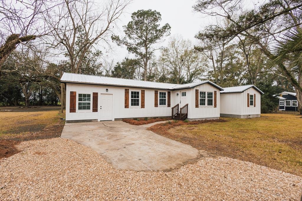 This charming, fully remodeled home offers peaceful country living with modern updates throughout. With three bedrooms and two bathrooms, the home features a beautifully updated kitchen with new cabinets and durable hard-surface countertops. You'll love the fresh feel from all-new light fixtures and the low-maintenance Hardie board plank siding. The layout includes two comfortable living areas, giving you plenty of space to relax, gather, or entertain. Tucked away in a quiet, secluded setting, this home is perfect for anyone looking for privacy, comfort, and move-in-ready convenience.