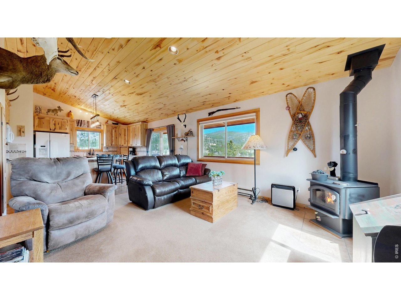 This Crystal Lakes cabin sits on 2.75-acre lot w/unobstructed views of the Crystal Lakes valley. Step inside to a newly enclosed fin mud room w/hardwood floors. Living rm w/vaulted tongue-and-groove ceilings create a warm cabin feel, while the kitchen features upgraded 42-inch hickory cabinets w/soft-close doors& drawers. Main level includes a private bedroom & updated full bath, while the finished walk-out basement adds flexible living space, an additional bedroom, & another updated bathroom. Detached two-car garage includes an attached heated multi-purpose room-perfect for a gym, office, or hobby space. Nestled at the end of a private cul-de-sac & surrounded by beautiful aspen trees & bordered by greenbelt on three sides, offers privacy, scenery, & true mountain charm. Outdoor features include a firepit, separate electric hook-up for RV parking, & a covered wraparound deck overlooking Panhandle Creek, nearby lakes, ponds, & sweeping mountain vistas. Enjoy everything Crystal Lakes has to offer, including Beaver Pond, hiking trails, private fishing, abundant wildlife, & endless outdoor recreation. Fully furnished including all major appliances, this mountain retreat is ready to enjoy from day one.