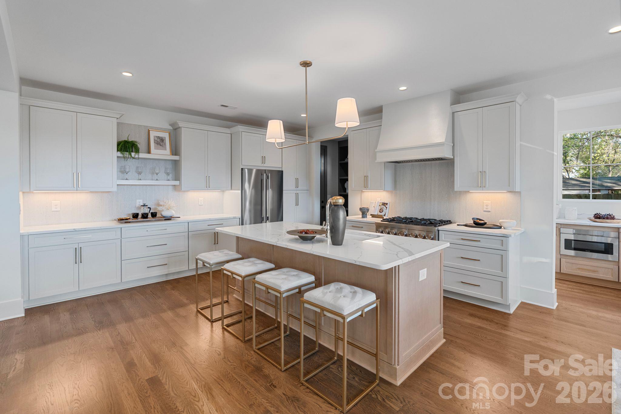 LIVE AT THE CENTER OF WHAT’S NEXT IN CHARLOTTE. Just steps from Camp North End, this striking modern home pairs incredible Uptown skyline views with a front-row seat to one of Charlotte’s most exciting and evolving destinations. Walk to restaurants, coffee, events, shopping and entertainment, then come home to space, privacy and unforgettable city views. From the moment you enter, the Uptown skyline becomes part of the home. Expansive windows and an open, modern design were thoughtfully positioned to capture the view while creating an effortless connection between indoor and outdoor living. The spacious kitchen anchors the main level with a large island and seamless flow into the living and entertaining spaces, while a separate back kitchen/scullery keeps prep, appliances and everyday clutter out of sight. Upstairs, the generous primary suite offers a private retreat with a large walk-in closet and beautifully appointed bath. Additional bedrooms and flexible spaces provide options for guests, a home office, media room or whatever life requires. Outside, enjoy a fully fenced backyard and covered patio with the Charlotte skyline as your backdrop. Walkable to Camp North End, minutes from Uptown and convenient to NoDa and Plaza Midwood, this is an opportunity to get into the area while the transformation around Camp North End continues. Major investment continues to transform the neighborhood, including plans for the future Red Line commuter rail and a proposed Camp North End station, making this an opportunity to get into the area as its next chapter takes shape. Modern architecture, substantial living space a private backyard and a skyline views, all in a location that keeps getting more exciting. SPECIAL FINANCING OPPORTUNITY! Qualified buyers can take advantage of a combined builder credit and lender credit of $30,000 towards a permanent rate buydown when working with our preferred lender. Builder credit and lender credit subject to buyer qualification and lender terms. Ask listing agent for details.