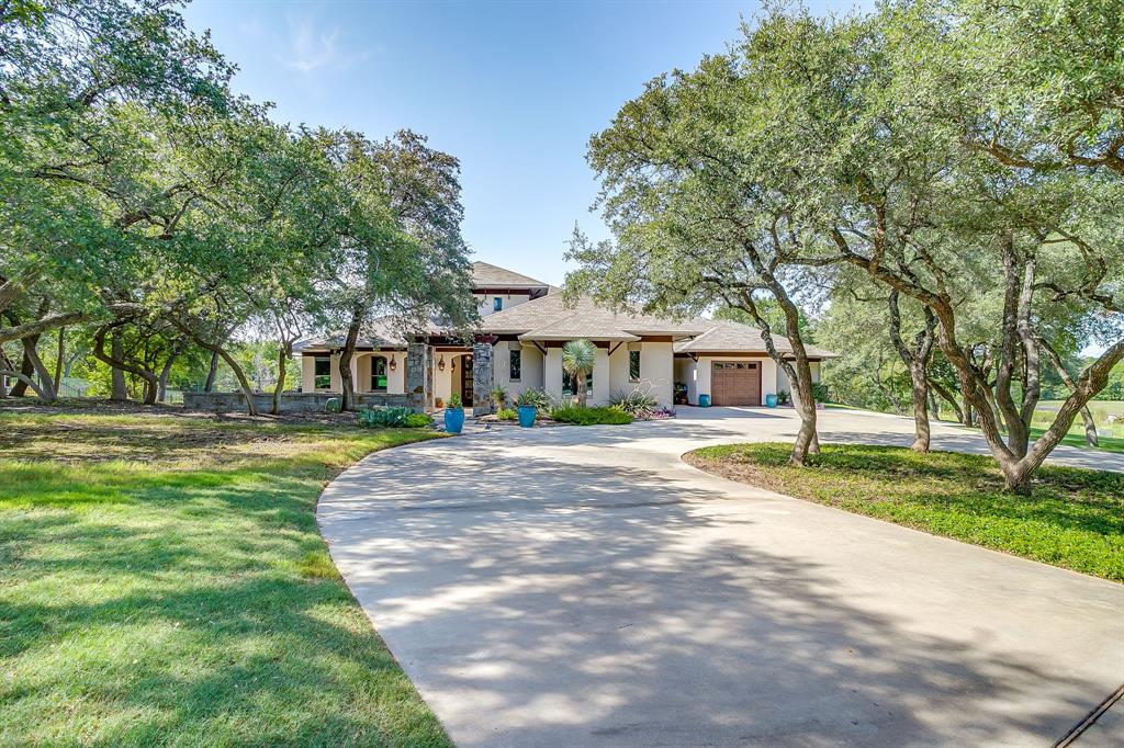 Walk into this luxurious custom home with many captivating details in custom ironwork, lighting and beautiful tile finish out in each bath and kitchen. This lovely 5-bedroom home sits on 1.24 acres in the La Cantera neighborhood. From the moment you walk through the front door you walk into the spacious living, kitchen and dining space with a wraparound porch on all sides. Enjoy the fully covered outdoor living space with seating, dining and full grill area. All of this overlooks a spectacular modern pool area. The kitchen boasts 2 dishwashers, subzero refrigerator and very spacious walk-in pantry. The primary bedroom has 2 large closets and adjoining bathroom. Enjoy the media room upstairs with full bar, game room and balcony overlooking the pool area. The garage space is oversized for large vehicles. New in Fall of 2024 is an additional well that is 595' deep, new Generac generator with a dedicated 1000-gallon propane tank, 2 tankless water heaters, additional attic insulation, exterior of house was painted and new screens on back porch.  You will be amazed at the amazing design details in this home. Come see!!