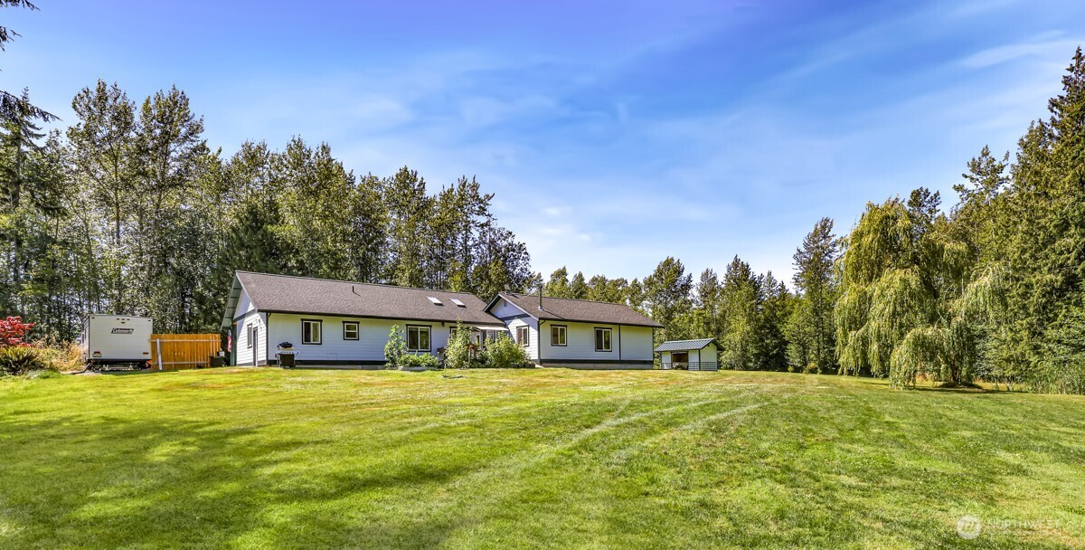 So many possibilities with this 9.9-acre property in a prime location near I-5. The bright and airy rambler features an open floor plan and two primary suites, offering comfort and flexibility. Unique zoning allows for an RV park, and the property currently generates $50,000+ in part-time annual revenue through RV parking and camping. The land is beautifully landscaped with gardens, fruit trees, and trails through the forest with private camping spots—creating a private sanctuary that feels far away yet remains close to amenities. Continue to grow the business, expand operations, or simply enjoy the peaceful setting while generating passive income.