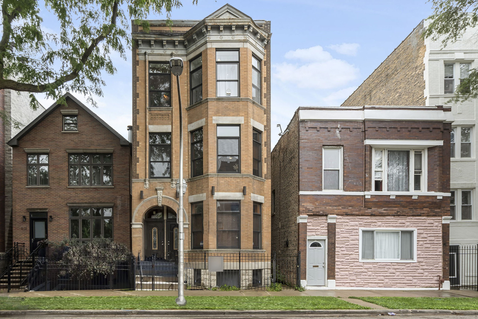 Prime location just steps from Humboldt Park!   This spacious 3 bed, 3 bath condo blends character and comfort with exposed brick and a smart, functional layout. The main level offers a generous primary suite with whirlpool tub, separate shower, and access to a private back deck, plus a second bedroom, full bath, and in-unit laundry. The lower level features a large living area, third bedroom, and den/home office-ideal for remote work or guests. Two tandem parking spots, low HOA dues, and a well-maintained building on a quiet, tree-lined street.